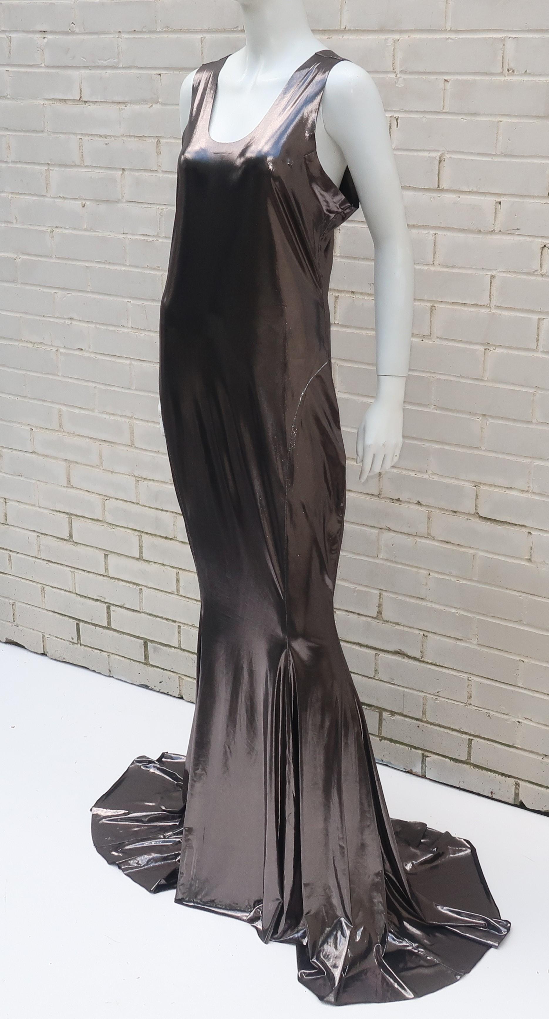 Norma Kamali combines the Hollywood golden era with a sporty racer back style to make this glamorous evening gown.  The unique dark pewter metallic fabric is a combination of polyester and spandex which offers a space age appearance and a body