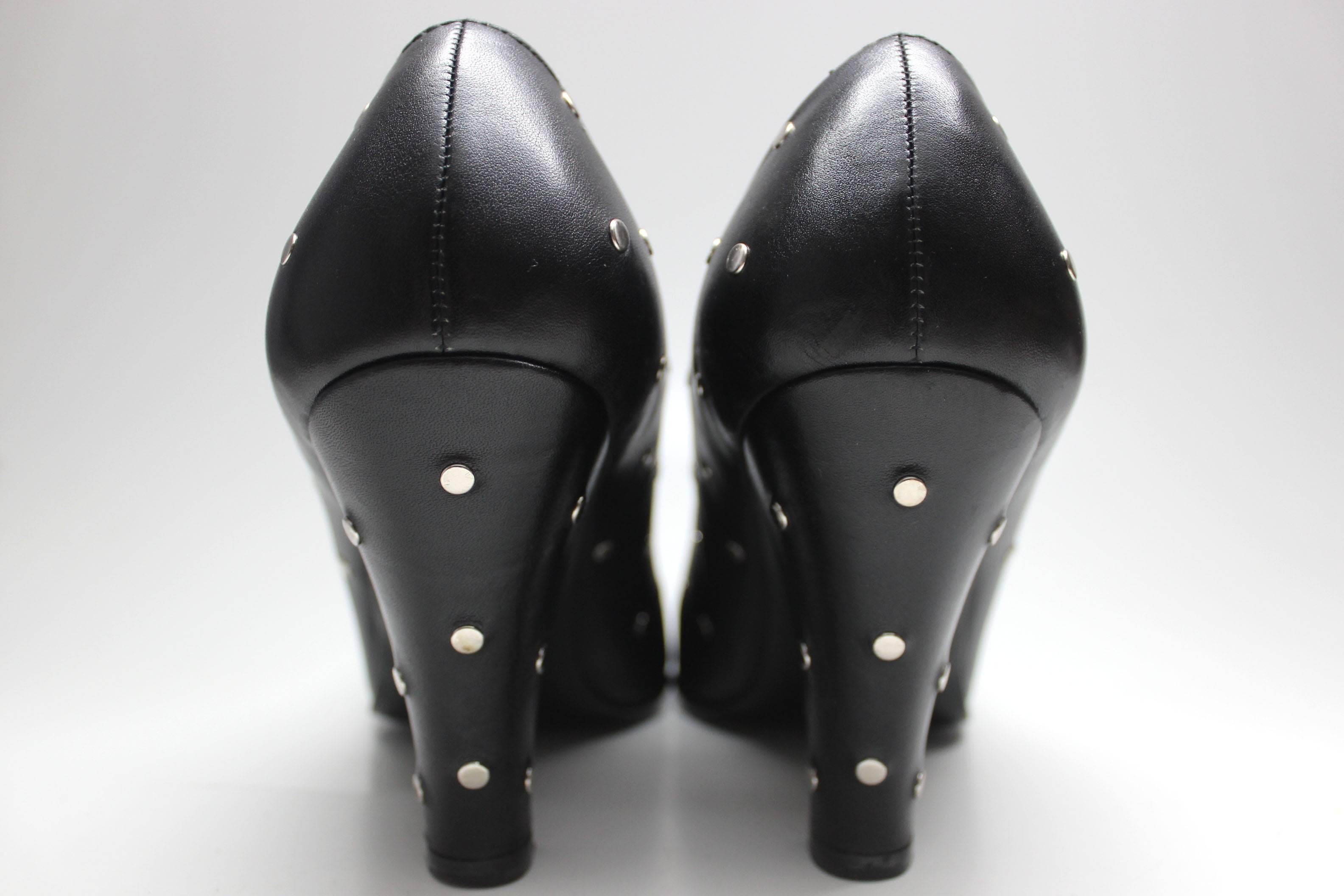 Sexy and playful, these heels are both punk and polished. Leather upper, silver dot studs throughout. Look especially great from the back with the studs on the heels! Round toe. 

Made in Spain
US Size 8