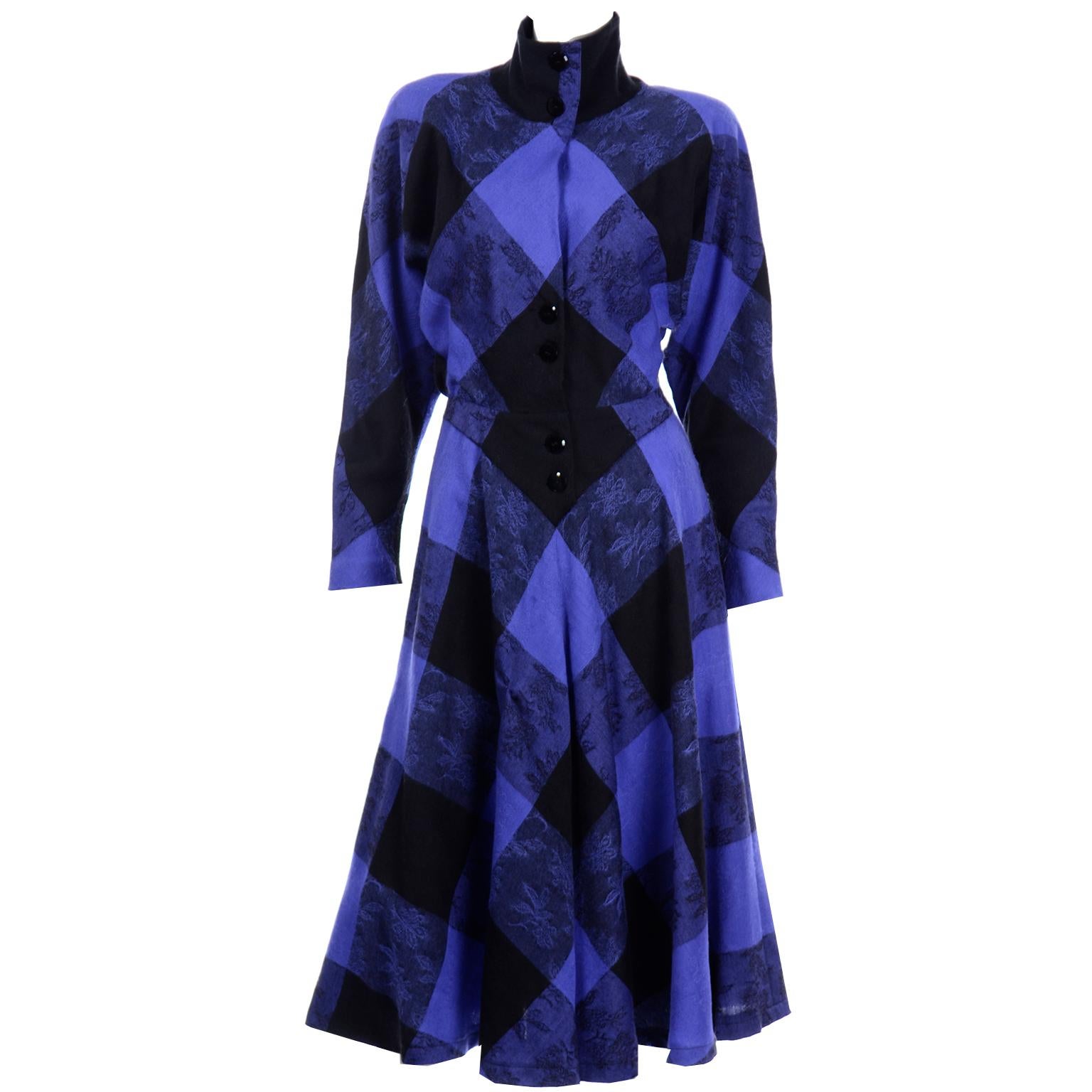 This vintage Norma Walters dress is such an easy to wear piece that can be buttoned up and worn as a turtleneck or worn with an open collar. This 100% Wool dress is in a blue and black plaid that has a subtle tonal floral pattern. If you've never