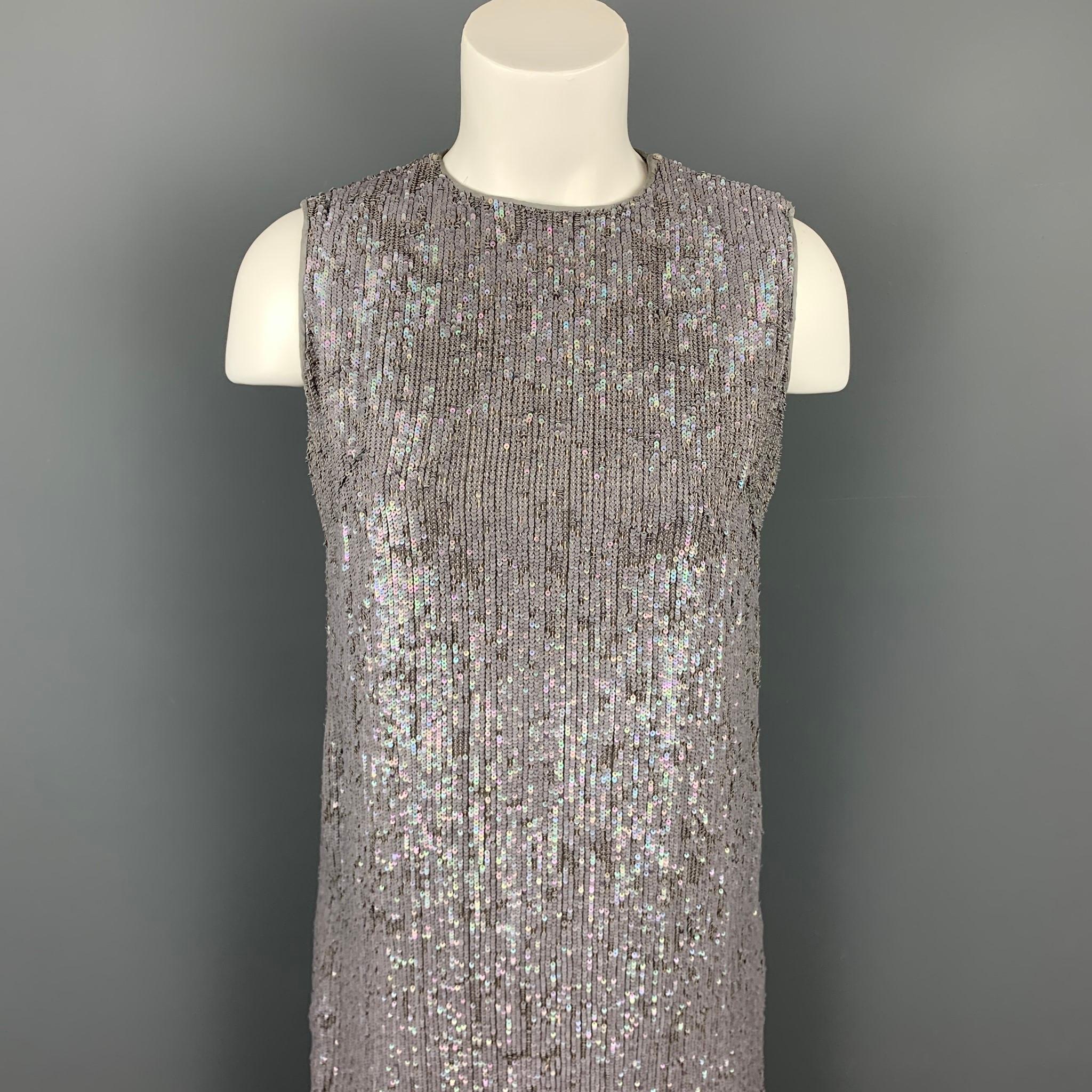 NORMAN AMBROSE cocktail dress in a slate silk with a iridescent sequin design featuring a shift style, hemmed mink fur panel, back button, and a shoulder hook & eye closure.

Very Good Pre-Owned Condition.
Marked: 4

Measurements:

Shoulder: 13