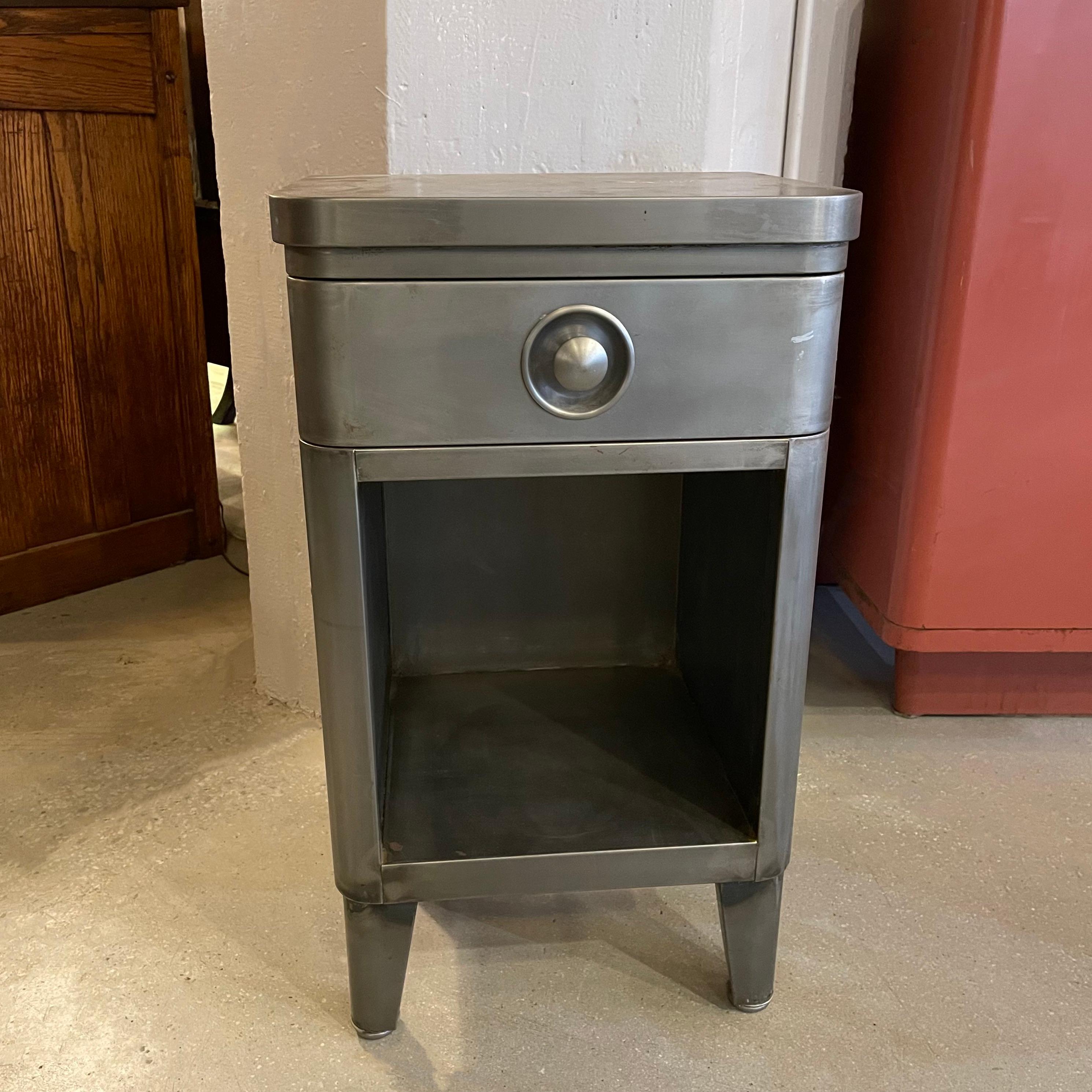 Machine-age, art deco, brushed steel nightstand or end table by Norman Bel Geddes for Simmons Company Furniture features a 3