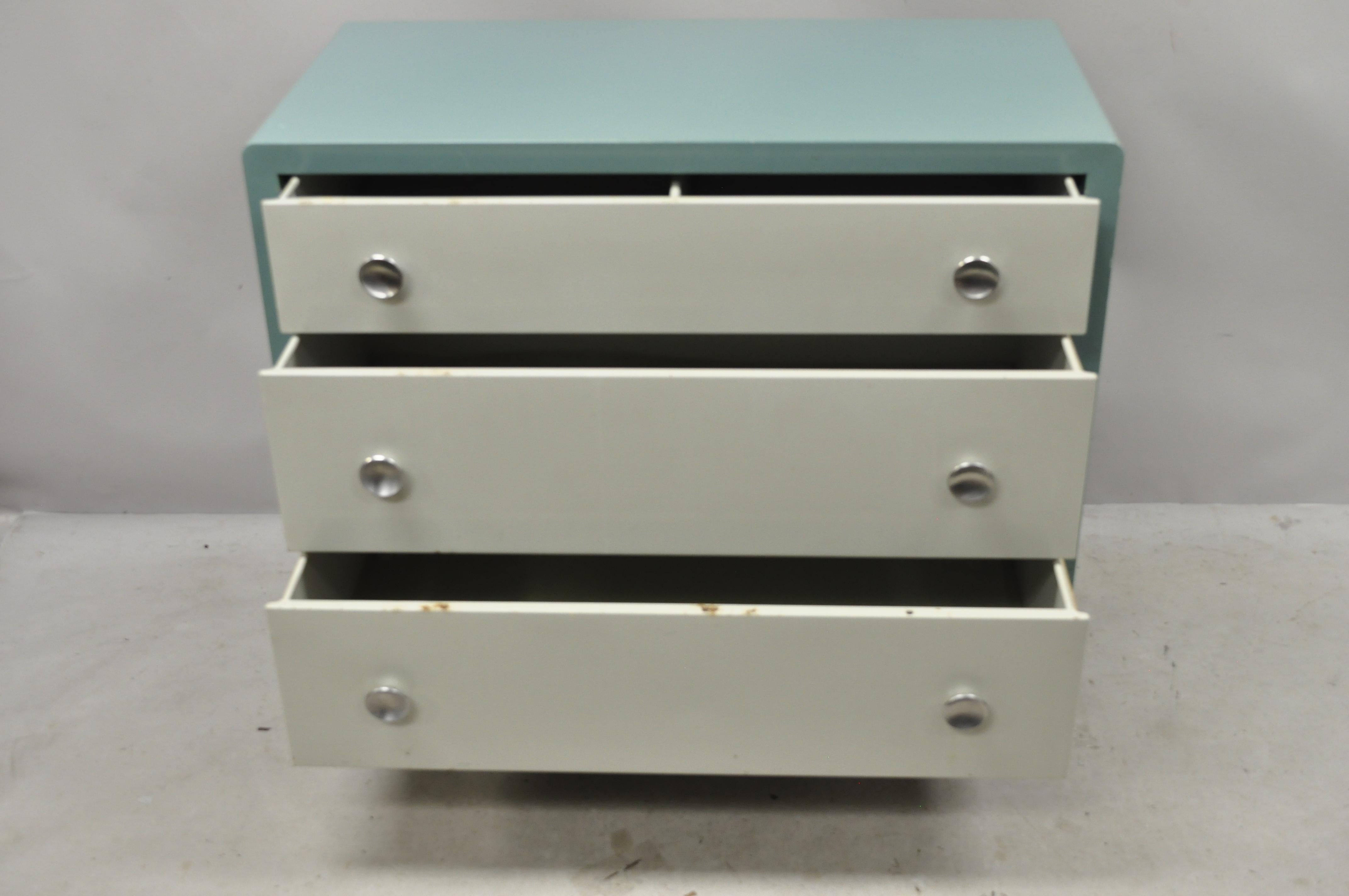Norman Bel Geddes for Simmons steel metal modern blue white dresser chest. Item features original aqua blue and white painted finish, steel metal frame, original label, 3 dovetailed drawers, circa early to mid-20th century. Measurements: 34