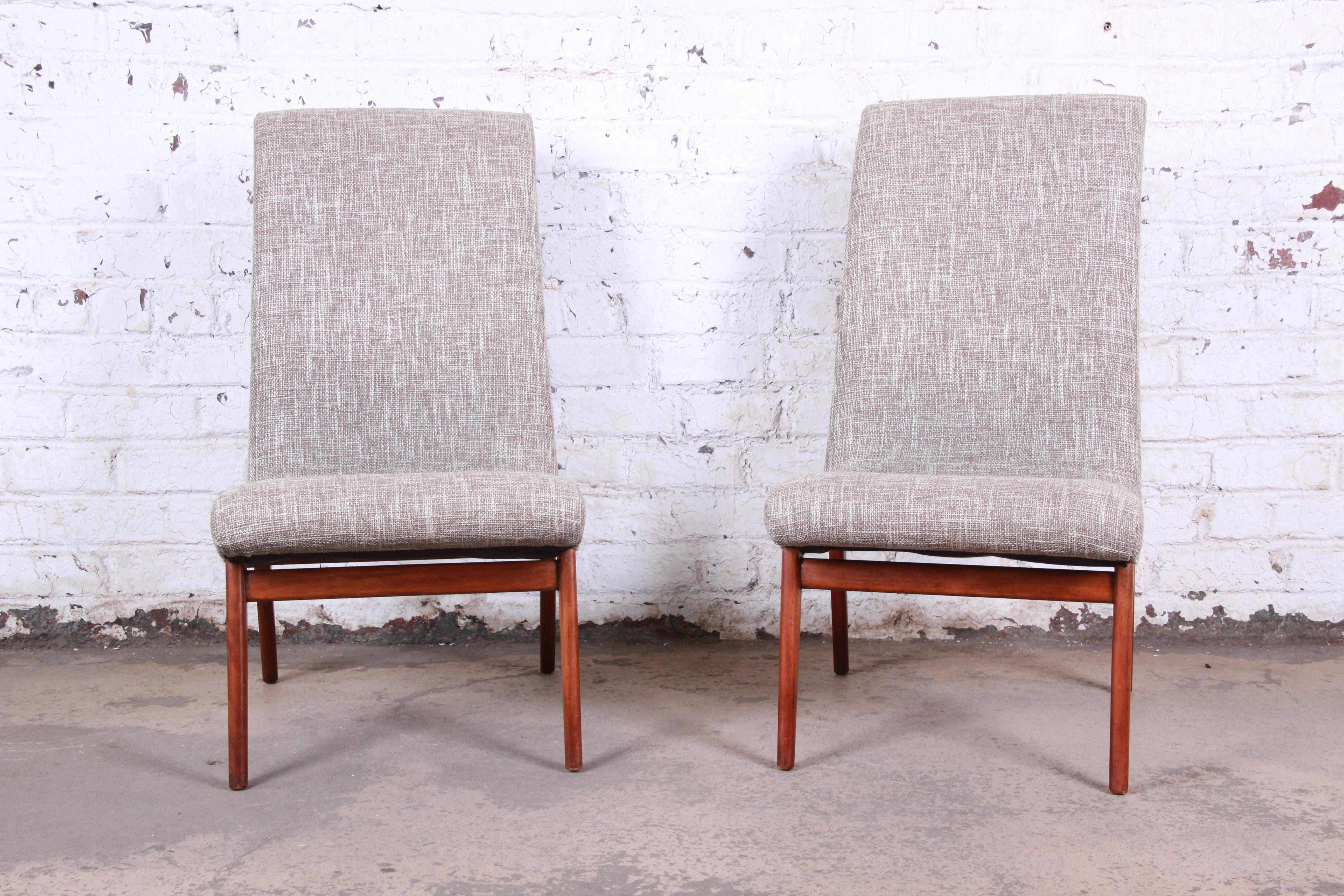 An exceptional pair of mid-century modern slipper chairs by famed American industrial designer Norman Bel Geddes for Valley Furniture, circa 1940s. The chairs have been newly reupholstered in gorgeous Knoll fabric in cream and tan. They have