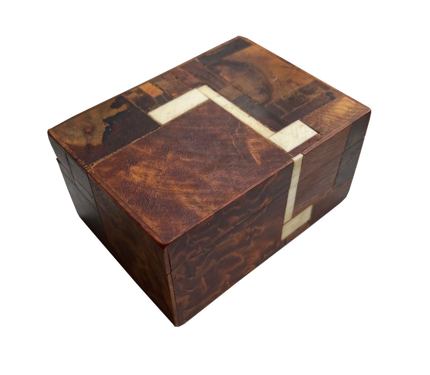 Brumm Handcrafted Wood Wood box with velvet interior.

This beautiful handmade inlaid wood decorative box by artist Norman Brumm (1939 - 2008) is an intricate work of art. Made up of pieces of wood of various sizes and species that reveal the grain