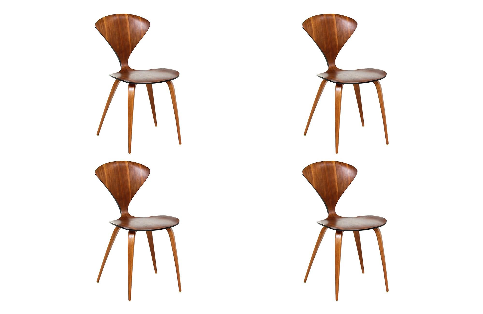 Iconic dining chairs designed by Norman Cherner for Plycraft in the United States in 1958. This set of four dining chairs are an early model of Cherners design as they maintain the original Plycraft label with the fabricated name, Bernardo as the