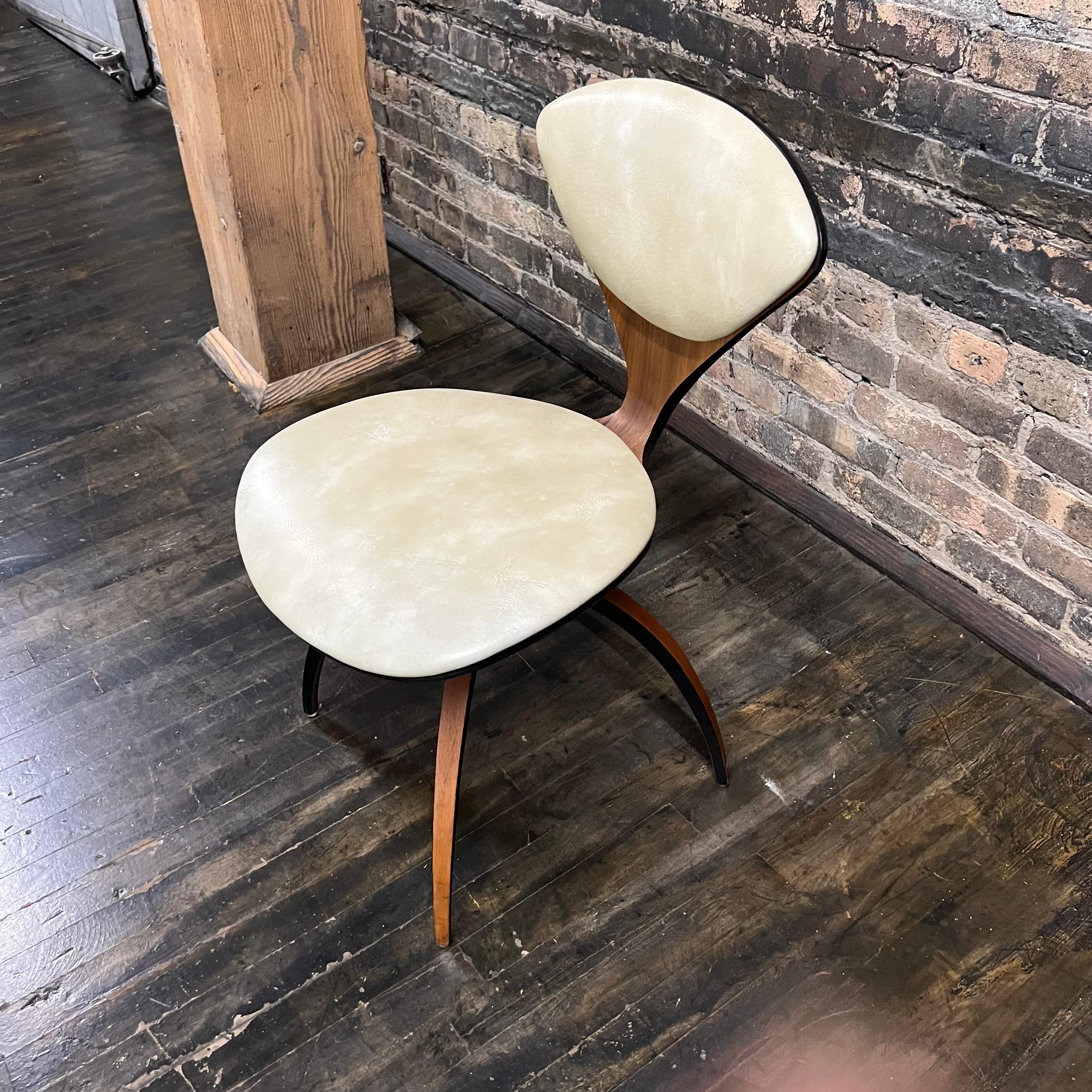 Attention Collectors! This architecturally captivating swivel chair designed by the acclaimed Norman Cherner is ideal for those searching for authentic Plycraft pieces from the early 60's. Constructed of walnut intricately bent in fabulous curvy