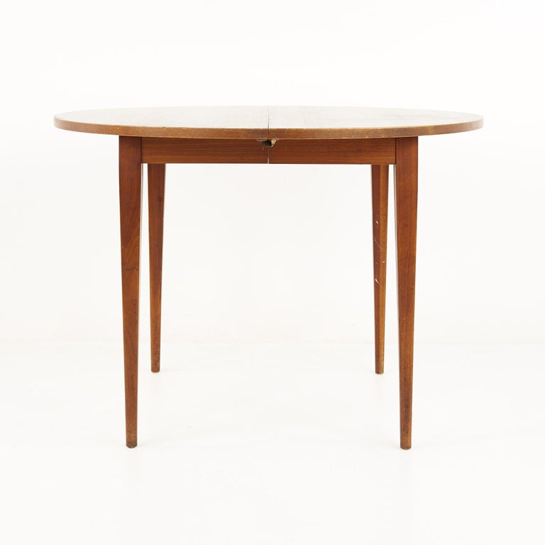 Norman Cherner for Plycraft mid century walnut round expanding dining table

This table measures: 42 wide x 42 deep x 29.25 inches high, with a chair clearance of 25.5 inches, each of the 2 leaves are 22 inches wide, making a maximum table width