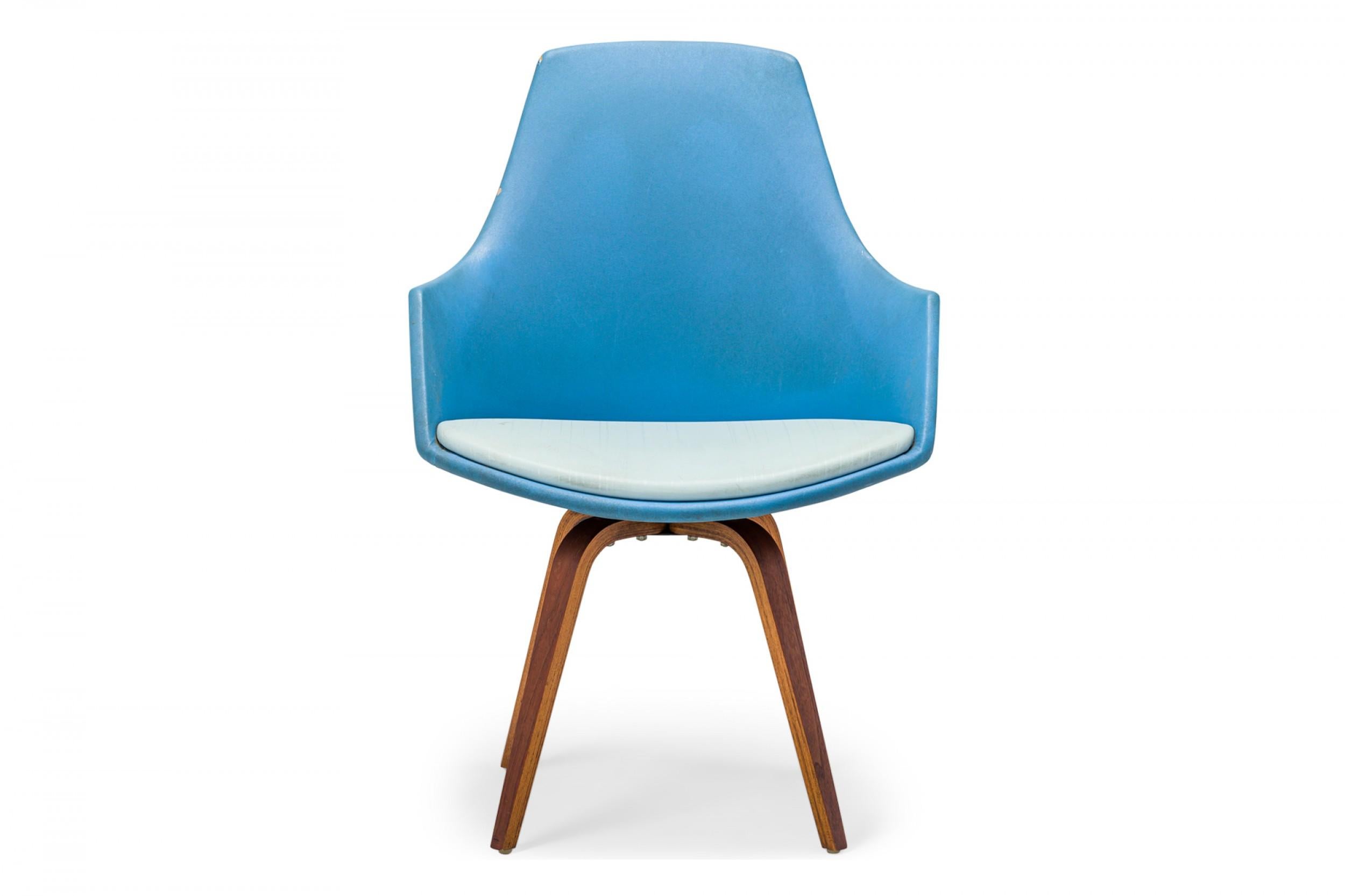 American Mid-Century swivel side / desk chair with a shaped seat and back upholstered in bright and light blue vinyl, resting on a four leg curved plywood base. (NORMAN CHERNER FOR PLYCRAFT)