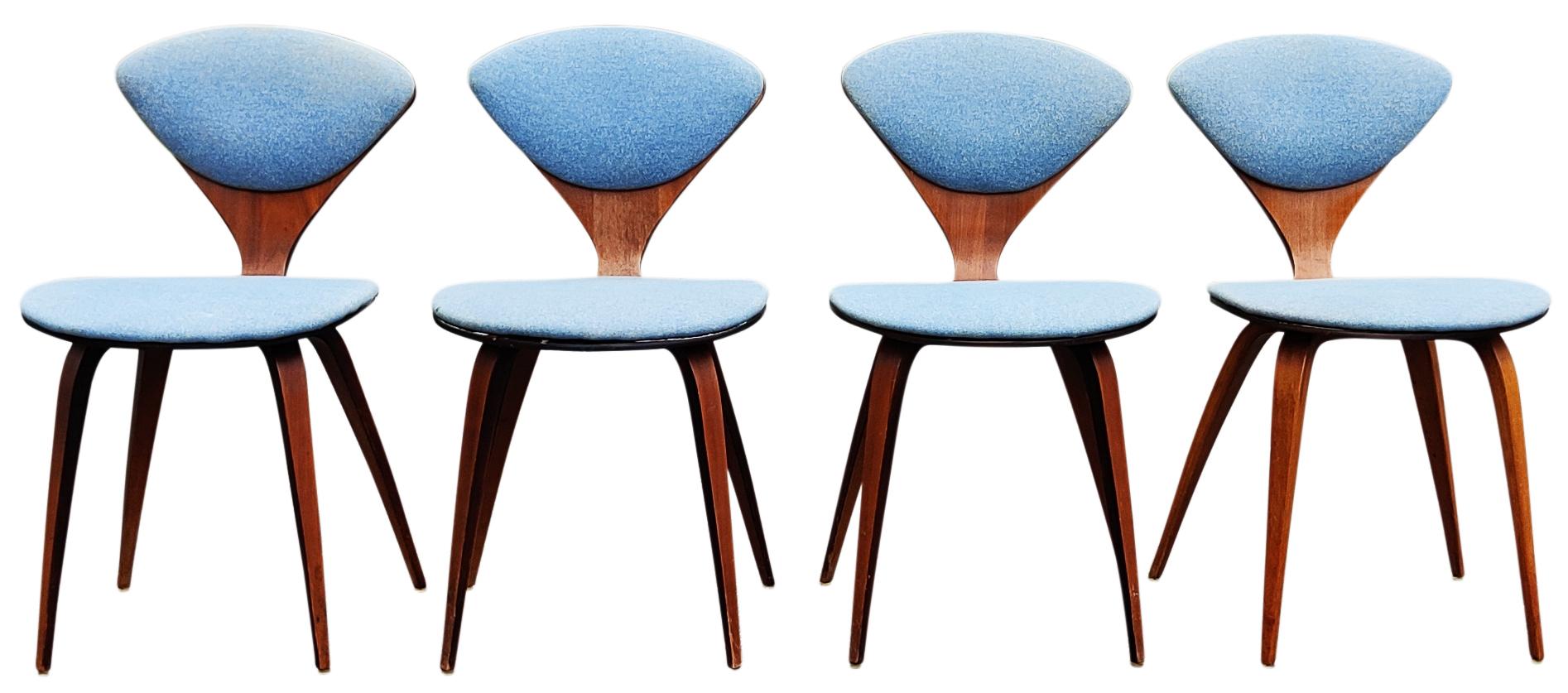 Iconic Pretzel side chairs (set of four) designed by Norman Cherner and made by Plycraft, 2 are still retaining original labels. Laminated walnut construction with older recovered blue upholstery. Surprisingly sturdy and comfortable. Please note, I