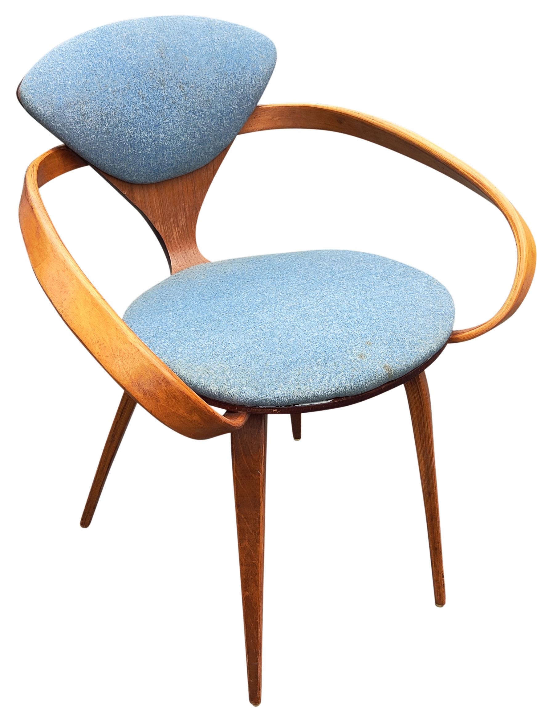 Iconic Pretzel armchair designed by Norman Cherner and made by Plycraft, still retaining original label. Laminated walnut construction with older recovered blue upholstery. Surprisingly sturdy and comfortable. Please note, I am offering four
