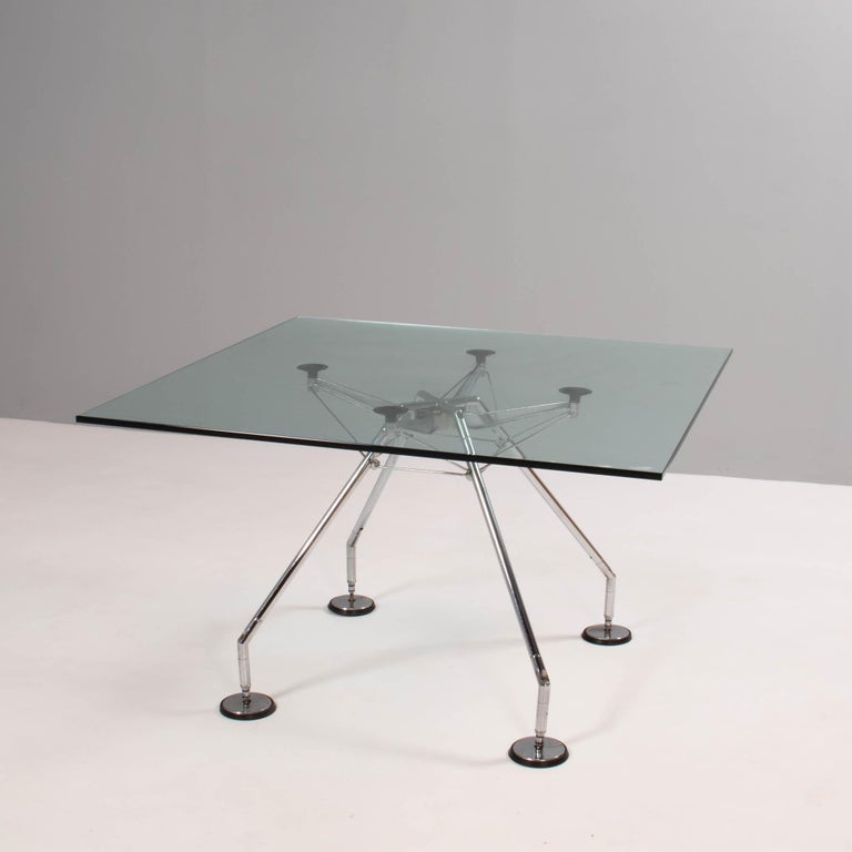 Originally designed by Sir Norman Foster in 1986, the Nomos table has an industrial post-modernist aesthetic.

Conceived as a zoomorphic skeleton, the base is the real focal point of the design, and the clear glass tabletop allows for an