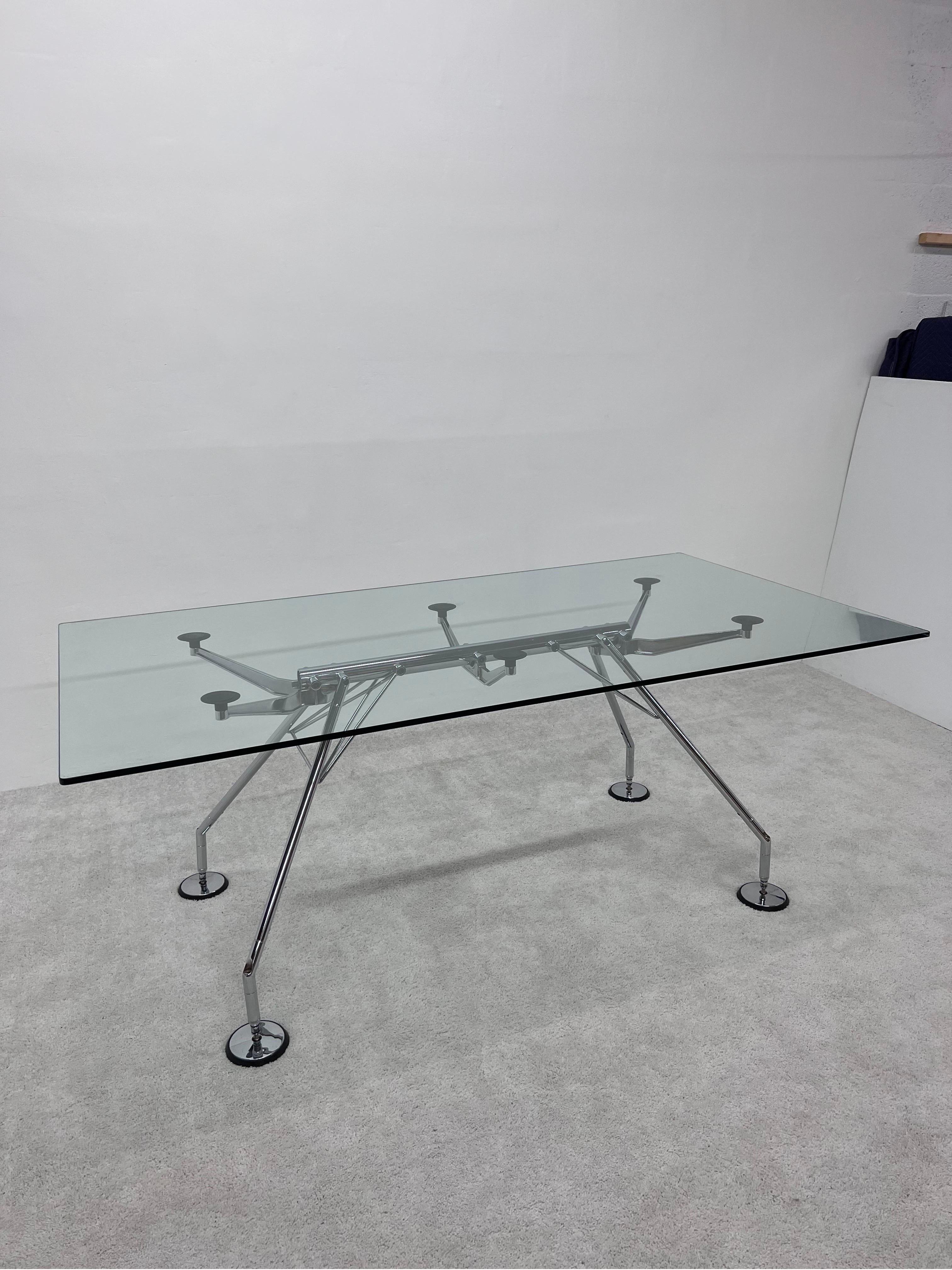 Sir Norman Foster designed Nomos dining or conference table with large rectangular glass top for Tecno Spa., circa 1986. 

The feet are height adjustable. 
Glass thickness: 1/2