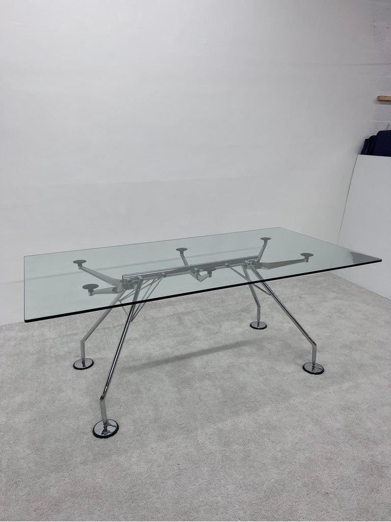 Sir Norman Foster designed Nomos dining or conference table with large rectangular glass top for Tecno Spa., circa 1986. 

The feet are height adjustable. 
Glass thickness: 1/2
