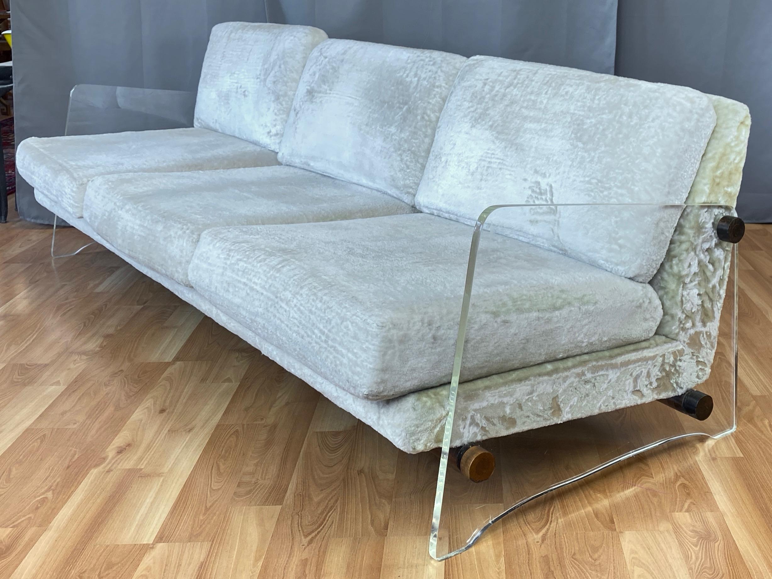 A rare extra-long late-1960s Monogram collection lucite-sided sofa designed by Norman Fox MacGregor exclusively for Sam Belz of Memphis.

Large .75”-thick lucite slabs have a clean yet commanding profile, and are connected by walnut rods that appear