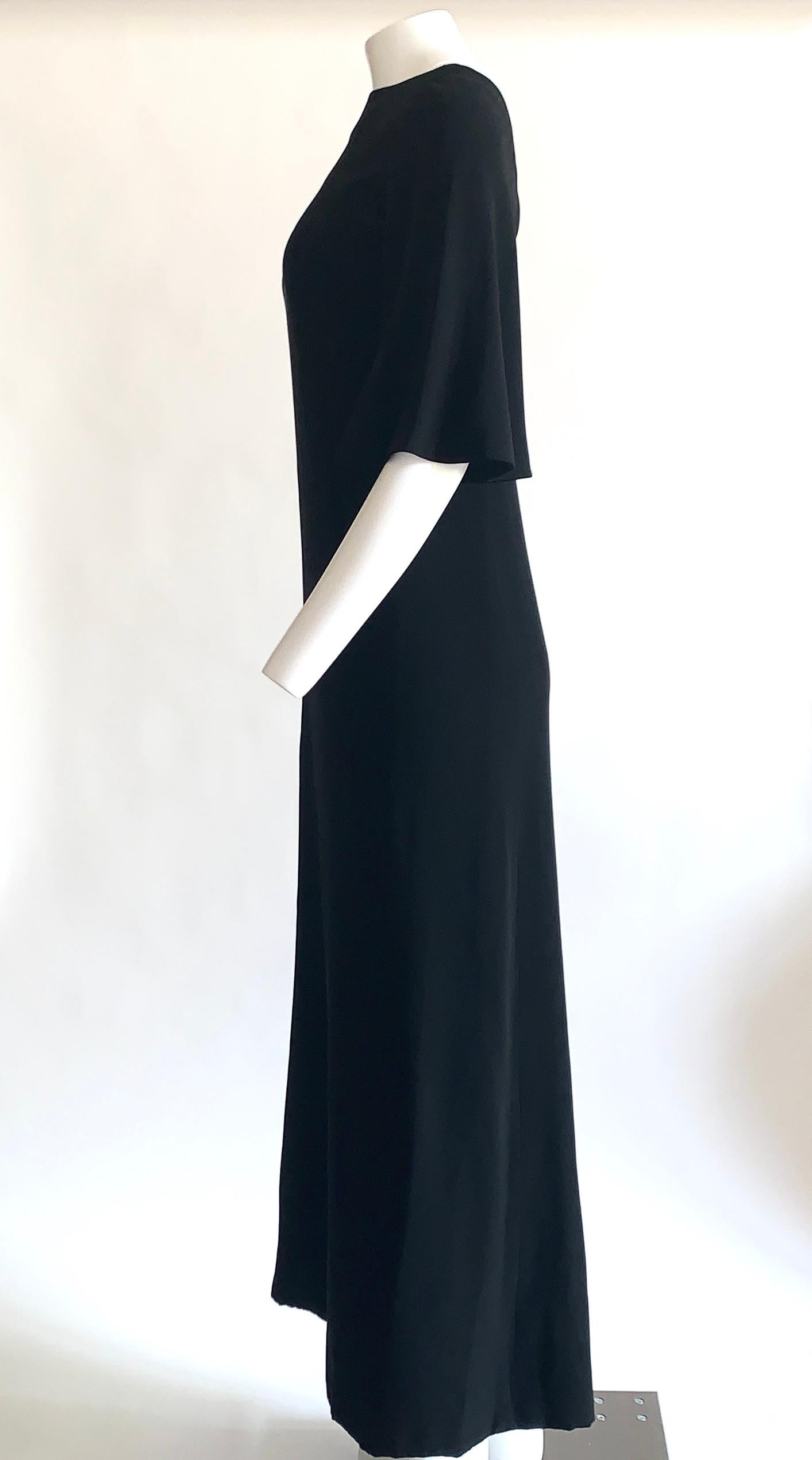 Vintage Norman Norell 1960s black silk maxi dress with scoop back and flared mid-length sleeve. A special piece that manages to be both iconically 60s in design but also completely modern. Emanates fun funky vibes when paired with acrylic jewelry,