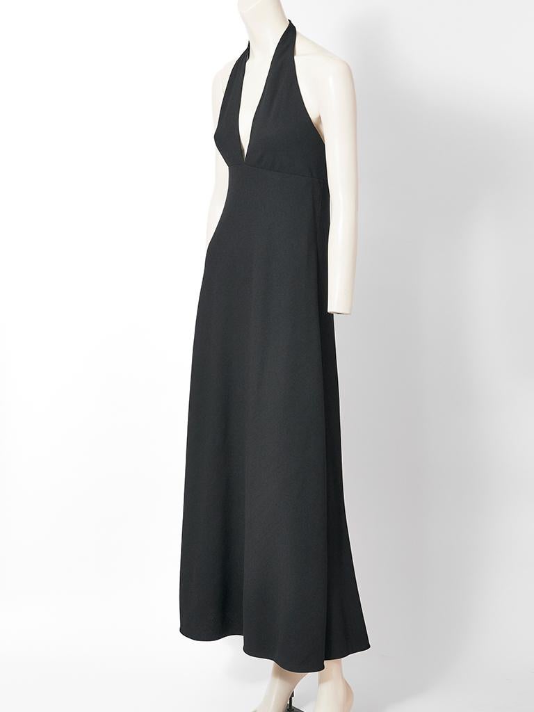 Norman Norell, black, wool, crêpe, halter neck gown, having a deep V plunging neckline, open back and a bias cut skirt. C. 1960's.
