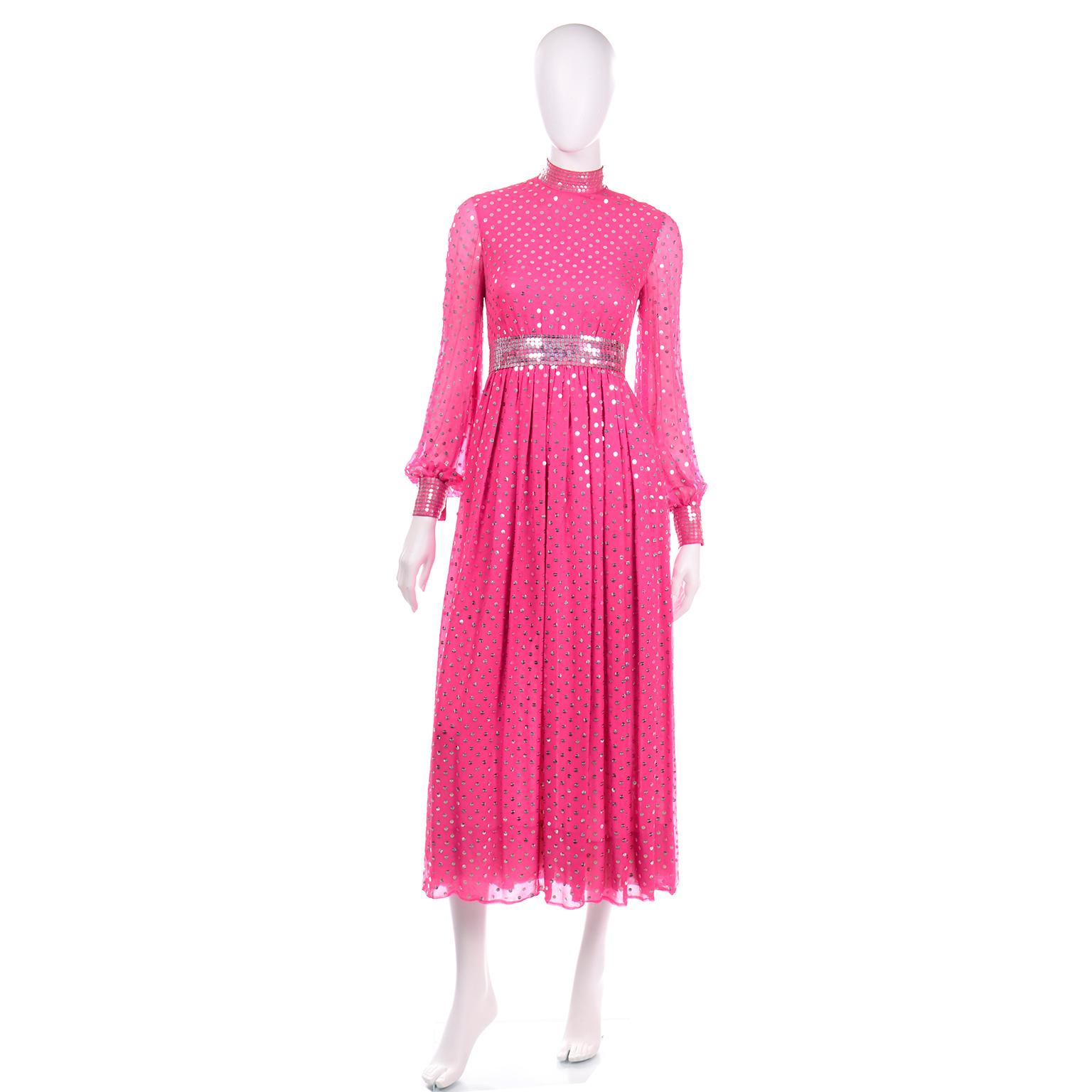 This vintage 1960's Norman Norell dress is beautifully made and is in pink silk embellished with beautiful silver and clear sequins that create a polka dot effect. The dress has a high neck, long, sheer sleeves, and is lined in a gorgeous nude silk