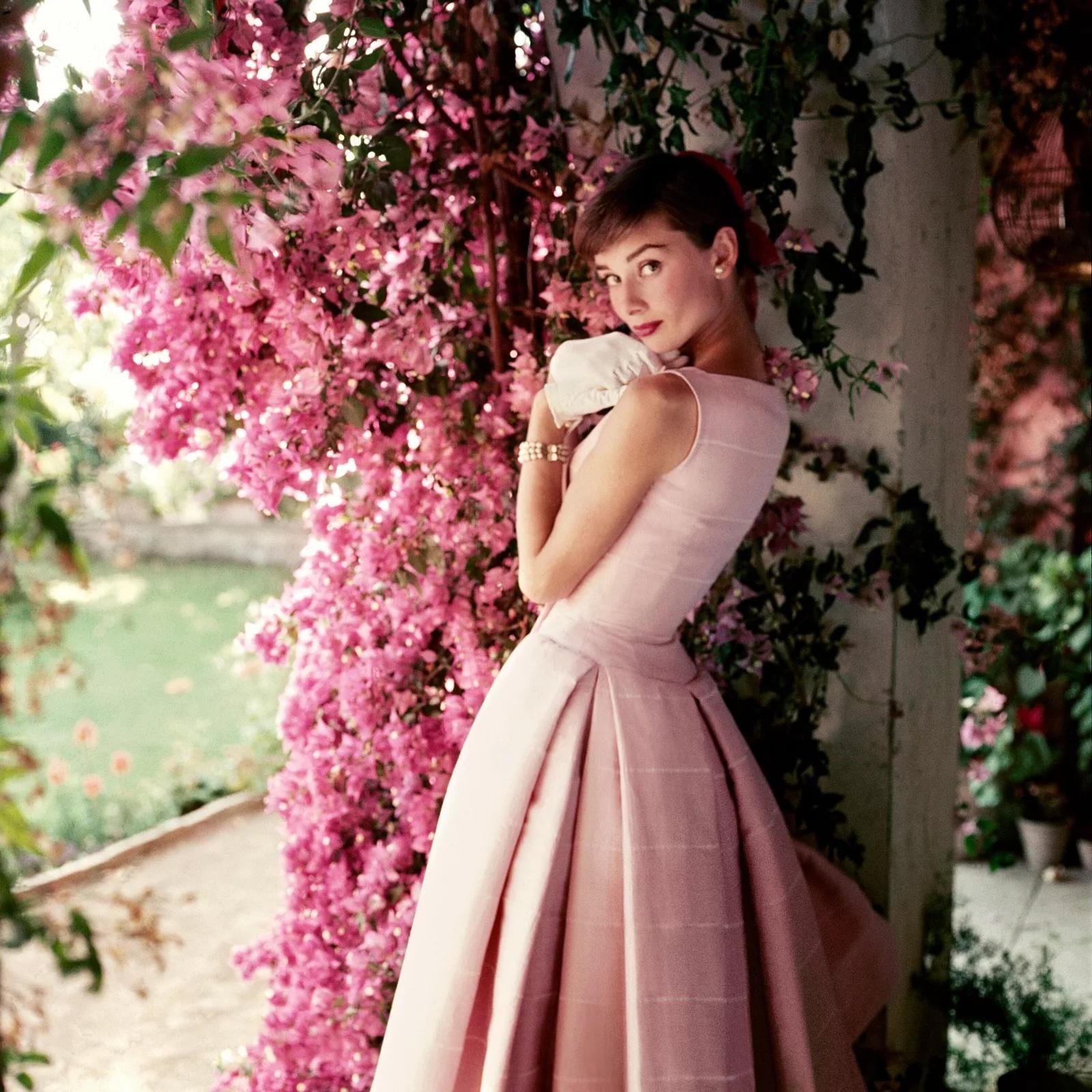 Die in Belgien geborene britische Schauspielerin Audrey Hepburn trägt ein Givenchy-Cocktailkleid aus der Kollektion Frühjahr/Sommer 1955 in der Villa Rolli, einem Bauernhaus in den Albaner Bergen von Cecchina, Italien, während der Dreharbeiten zu