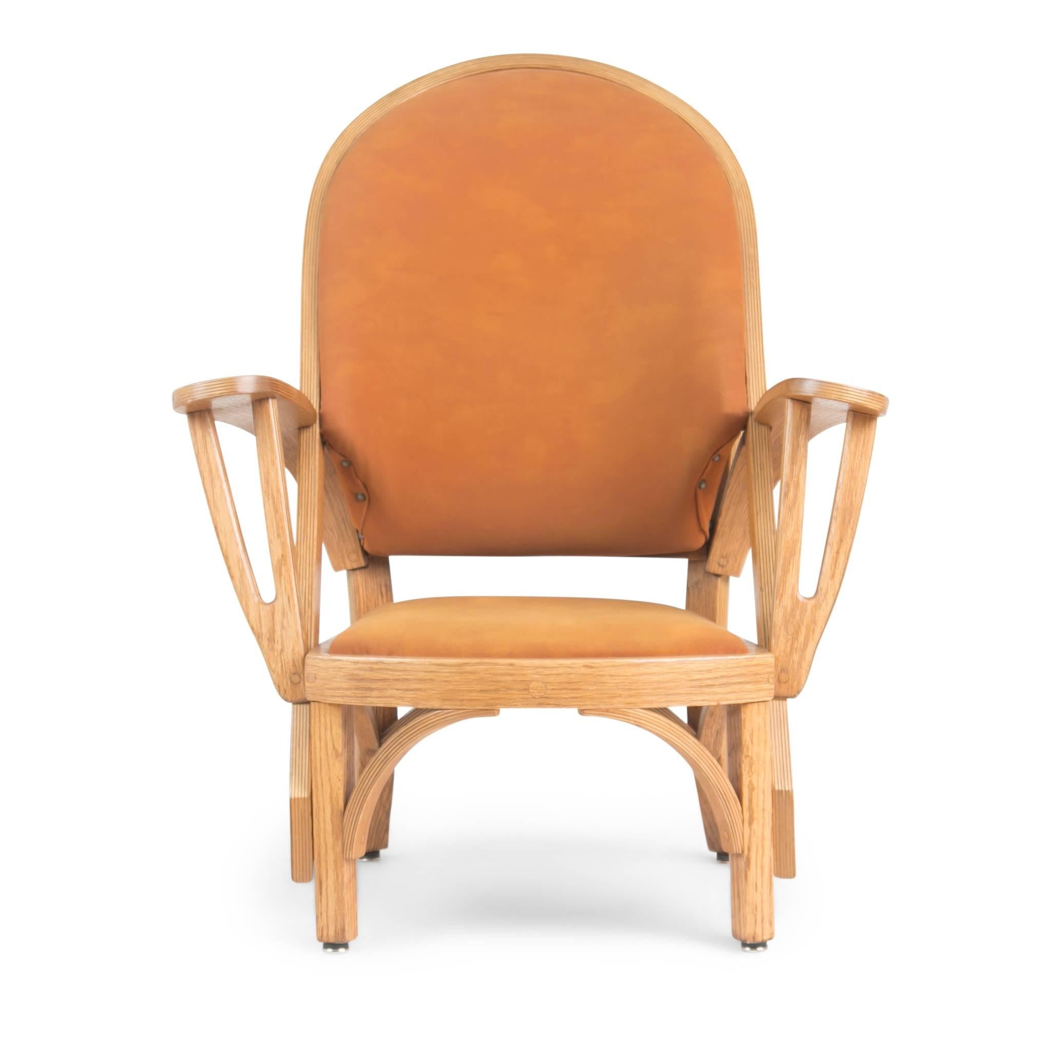 Pair of custom-made Norman Ridenour bentwood armchairs. This set of low lounge chairs feature sculptural bentwood frames fabricated from oak and are upholstered in an orange tone suede leather punctuated by studs close to the arms. These have been