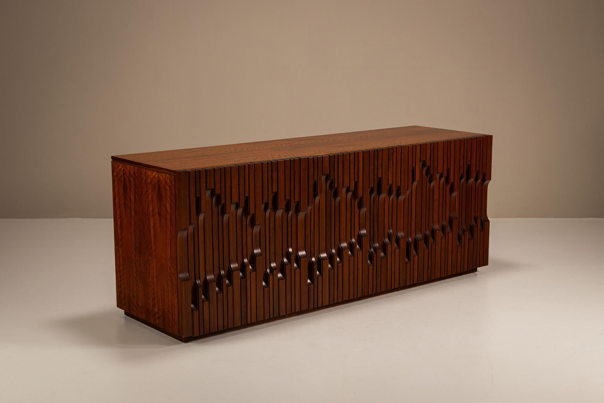 This sideboard from the “Norman” series, crafted in Italy during the 1970s, is a fine example of Frigerio’s design philosophy, where musical influence, artistic flair, and master craftsmanship converge.

Design
Made from richly figured African