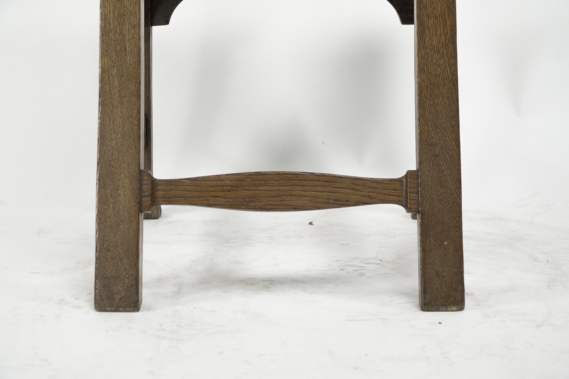 Norman & Stacey attributed. An Arts and Crafts high with shaped back oak chair For Sale 7