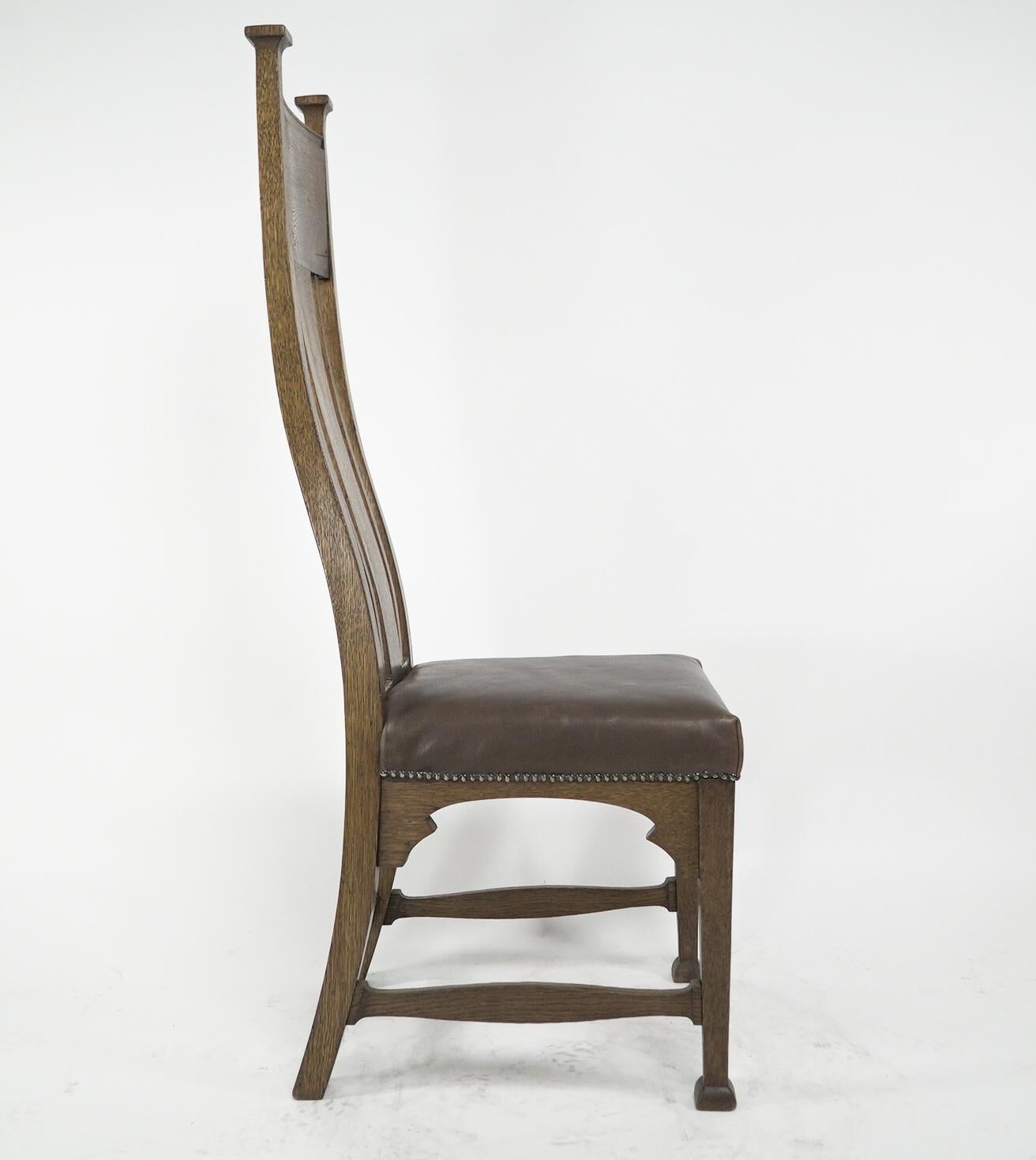 British Norman & Stacey attributed. An Arts and Crafts high with shaped back oak chair For Sale