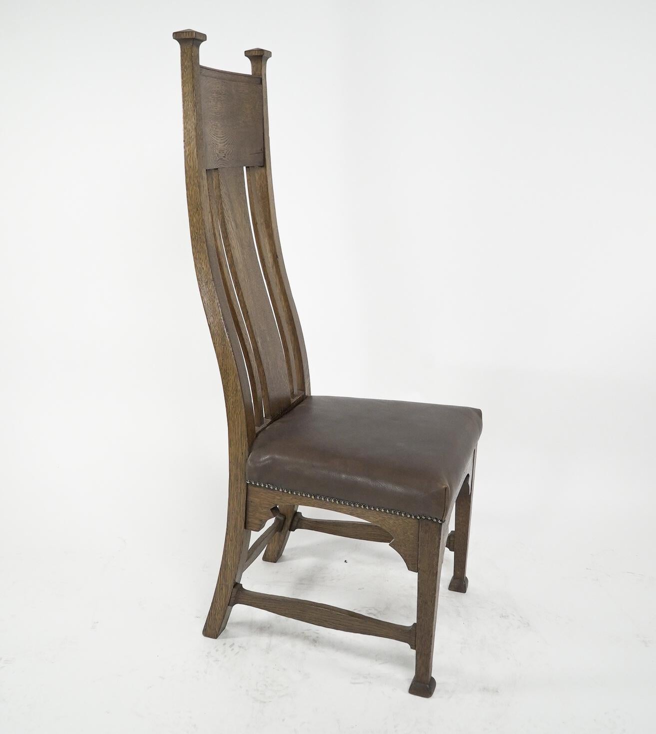 Hand-Crafted Norman & Stacey attributed. An Arts and Crafts high with shaped back oak chair For Sale