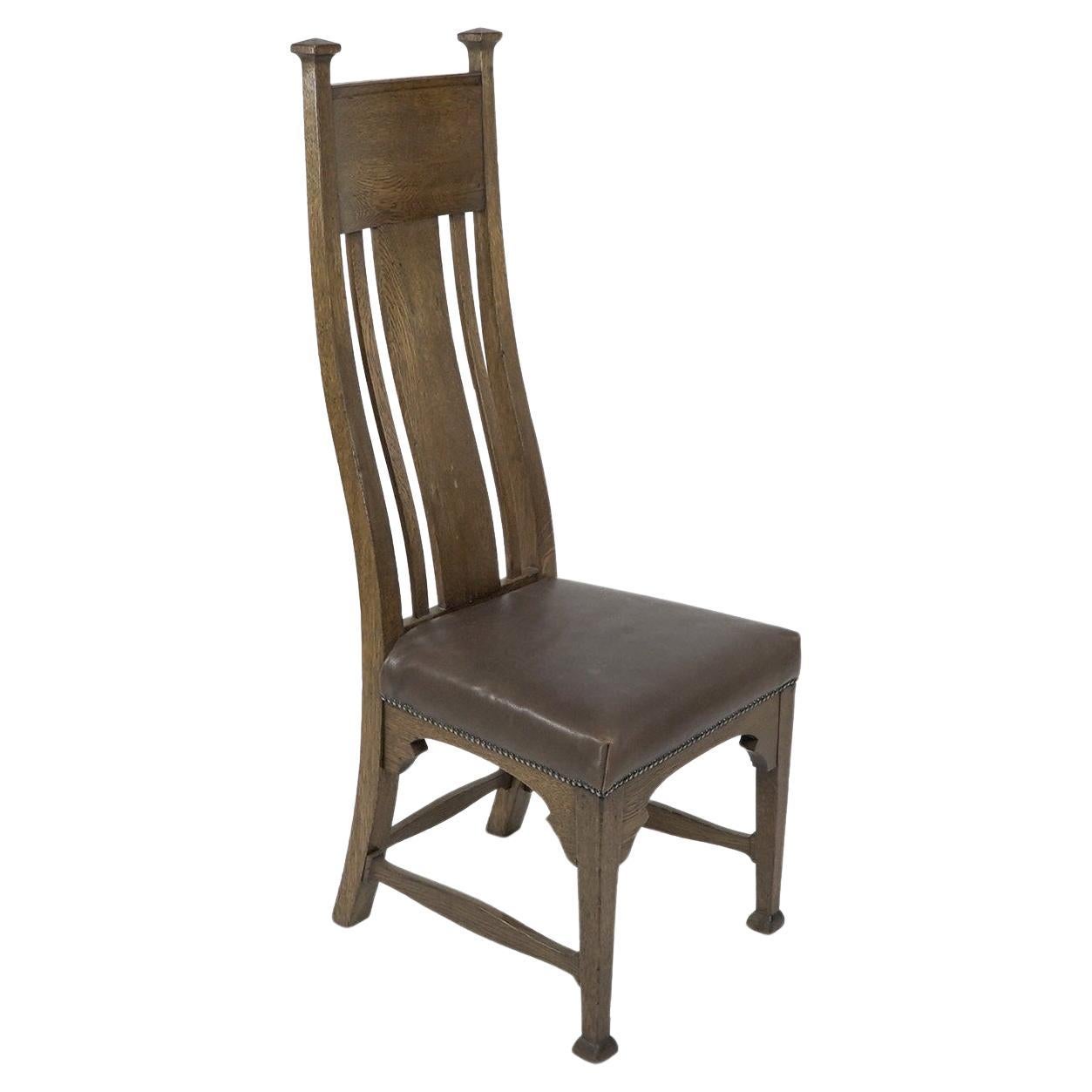 Norman & Stacey attributed. An Arts and Crafts high with shaped back oak chair For Sale