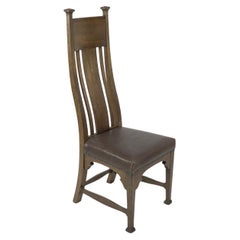 Used Norman & Stacey attributed. An Arts and Crafts high with shaped back oak chair