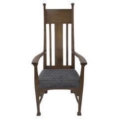 Norman & Stacey (attributed). An Arts and Crafts walnut high back armchair