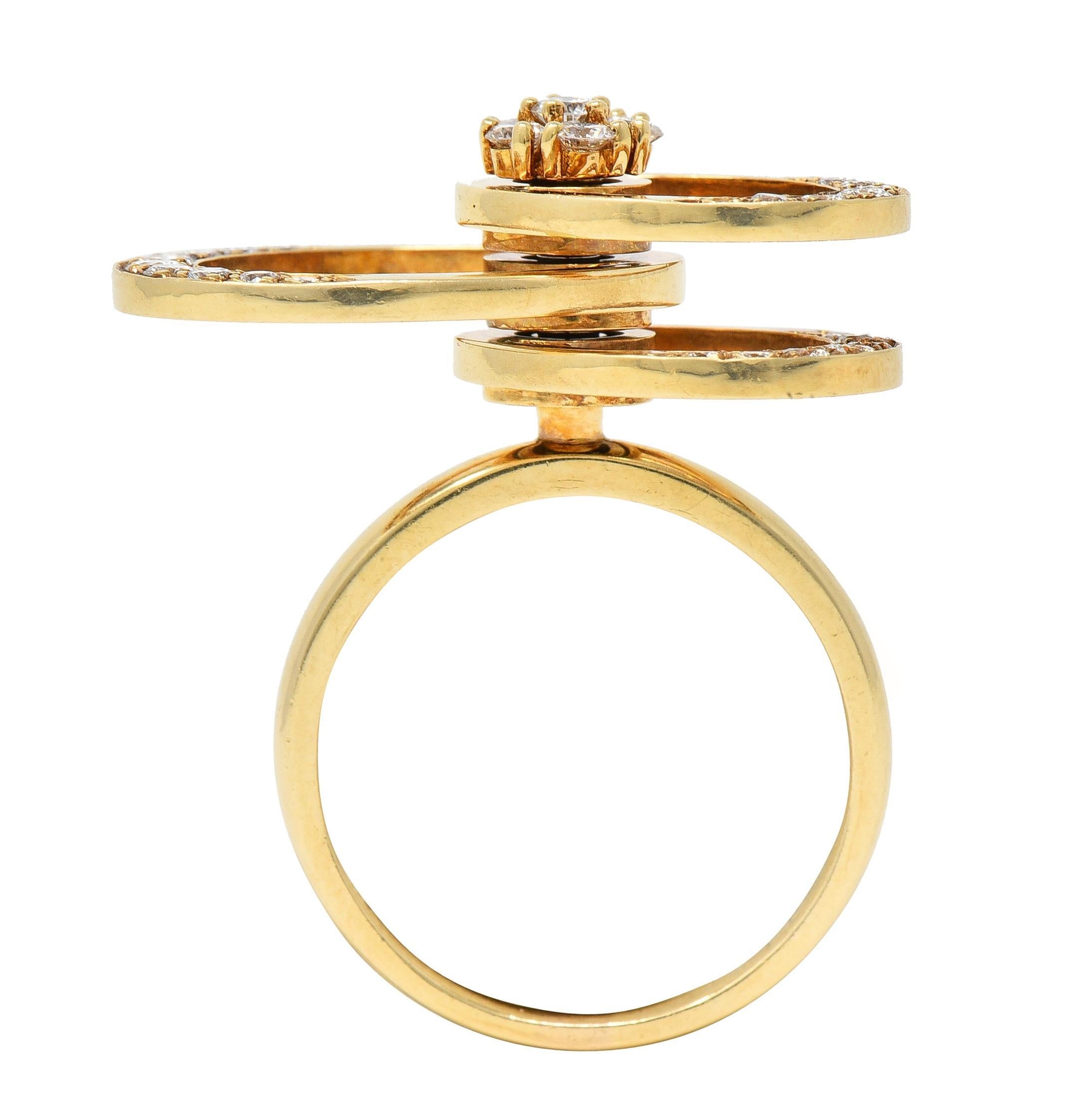 Featuring three oval-shaped rings pierced and stacked on a post - spinning with kinetic movement
Top of post features round brilliant cut diamonds prong set in a floral motif cluster
With additional diamond bead set on edges of ovals 
Weighing