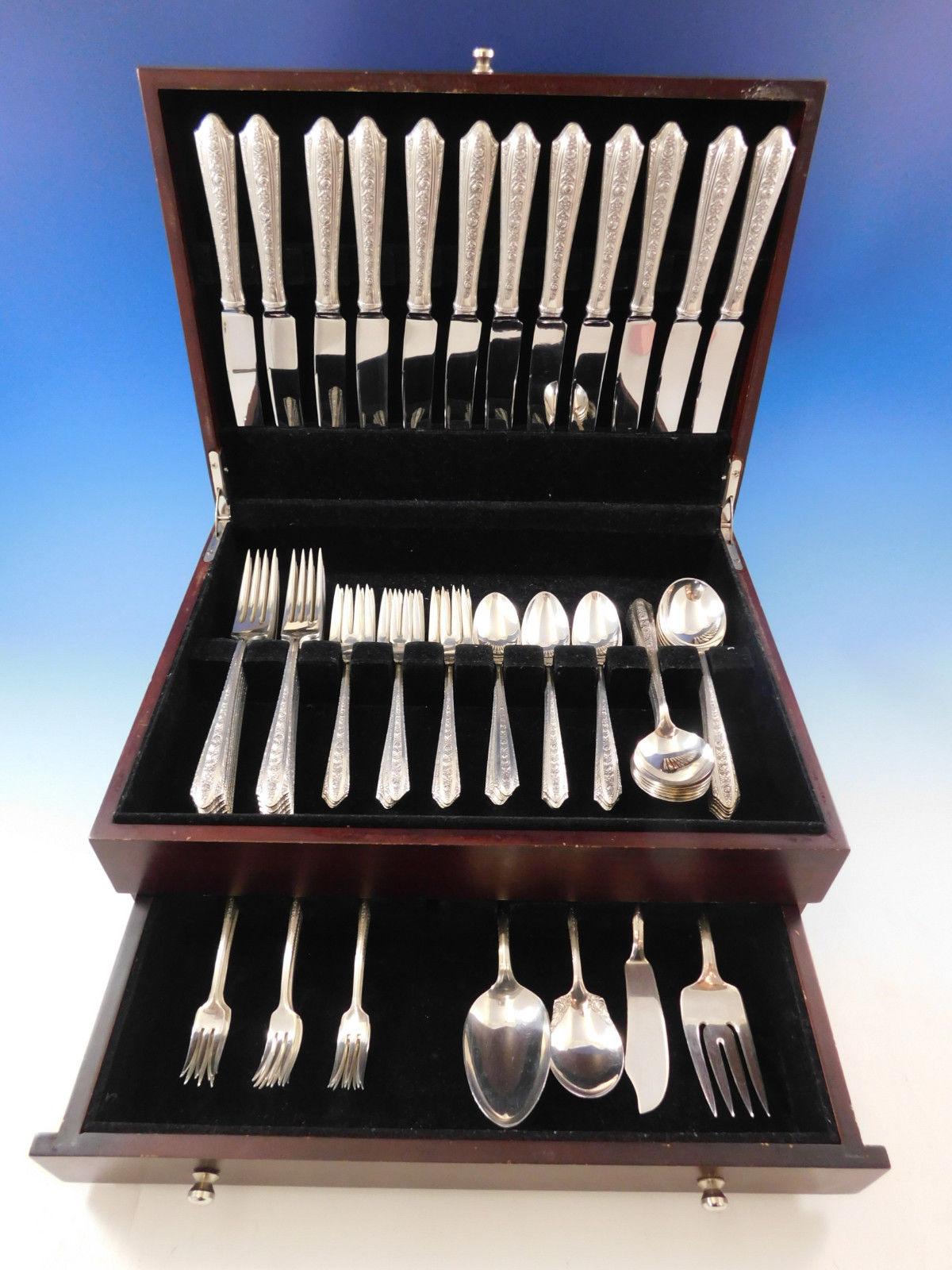 Exquisite dinner size Normandie by Wallace sterling silver flatware set with rose motif - 76 pieces. This set includes:

12 dinner size knives, 9 3/4