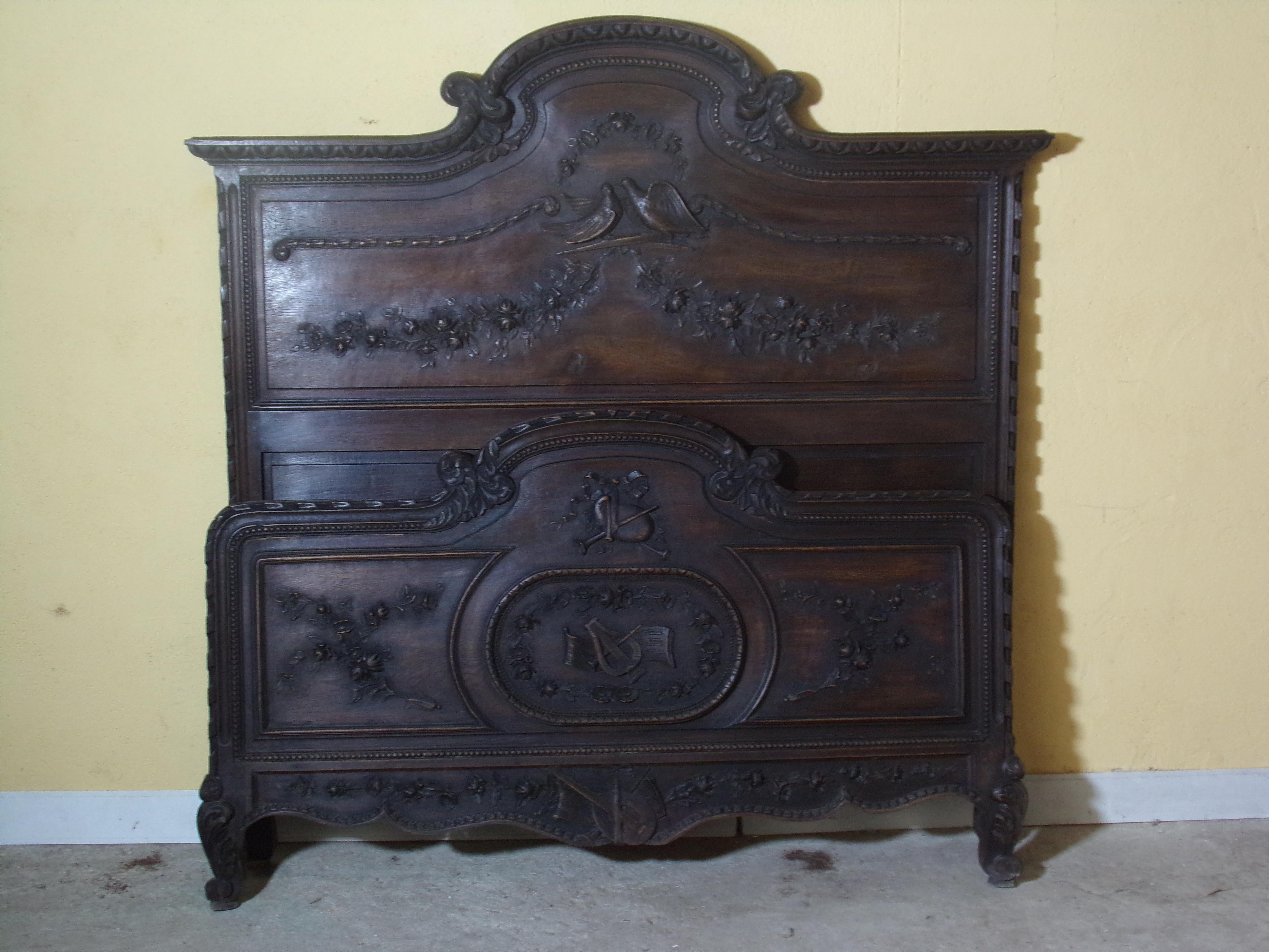 An outstanding and beautifully hand carved marriage bed and bedside cabinet from the Normandy region of France in Oak C1890 - perhaps the best to come to the market in many years. profusely carved with the symbols of marriage, love, happiness and