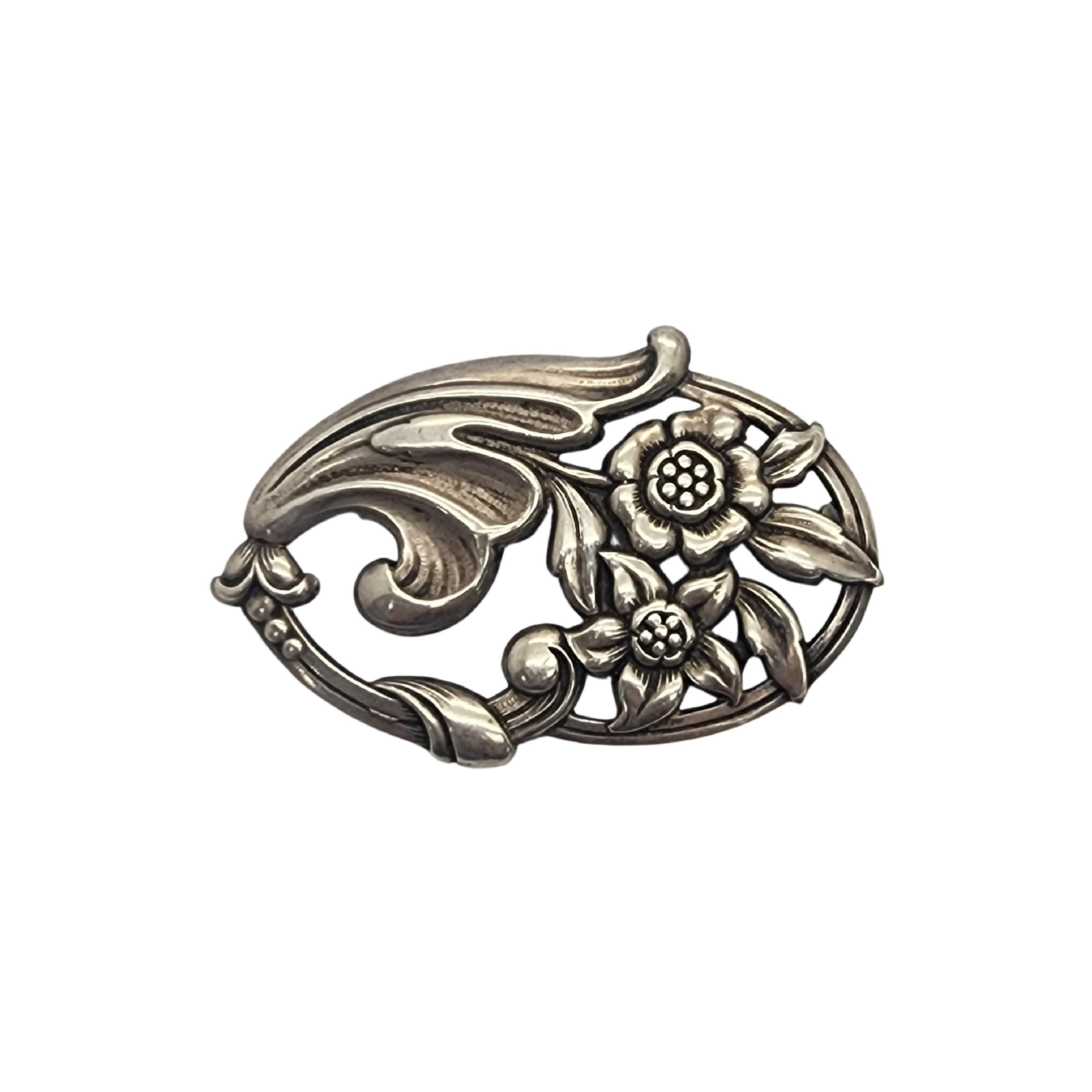 sterling silver oval flower pin/brooch by Norseland for Coro.

Norseland is Coro's highest end line of jewelry. This pin features flowers and leaves in an oval frame with berry accents. 

Measures approx 2 1/2