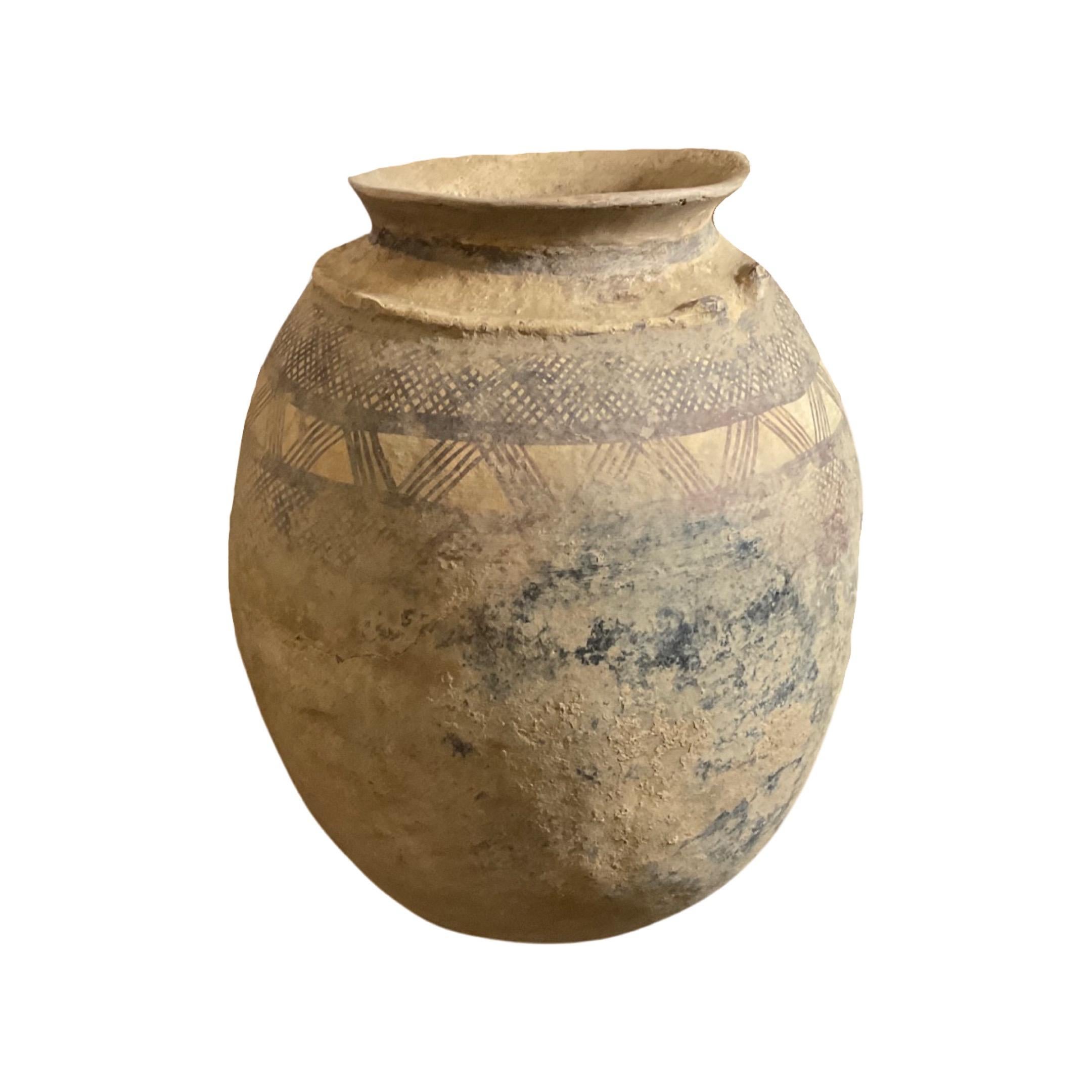 This antique North African terracotta vessel is a rare find, complete with a sturdy base holder for added stability. Its faded and unique African-inspired designs, dating back to the mid-1800s, add character and charm to any collection. Crafted