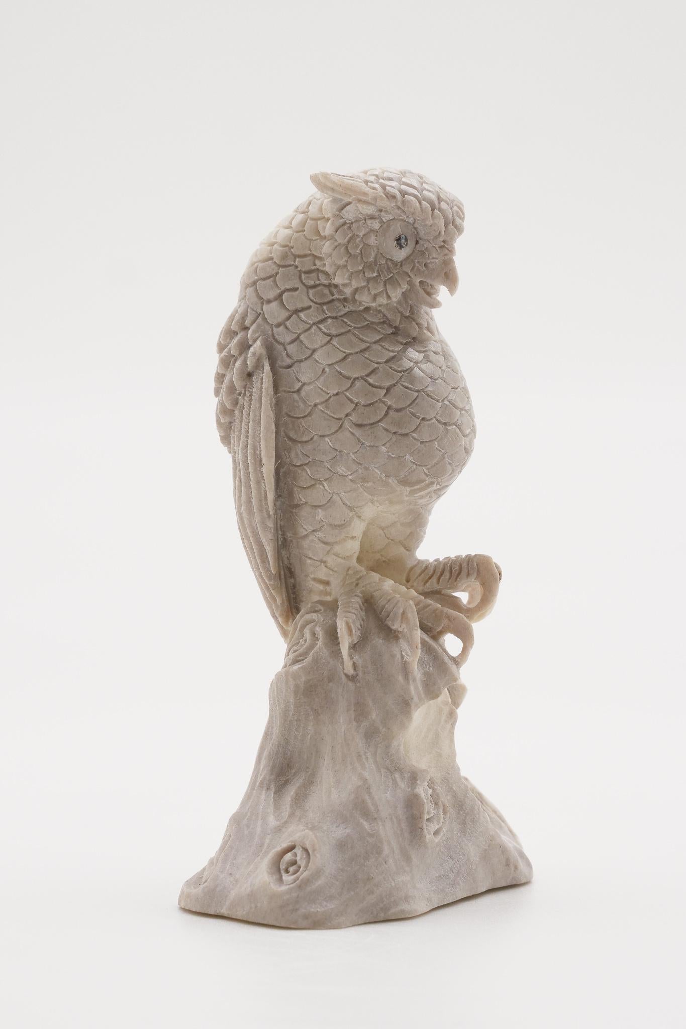 Moose antler carving of a perched horned owl. Antler was sourced in North America, then sent to Asia for carving. Quality of ivory, but with sustainability, as the moose naturally shed their antlers.