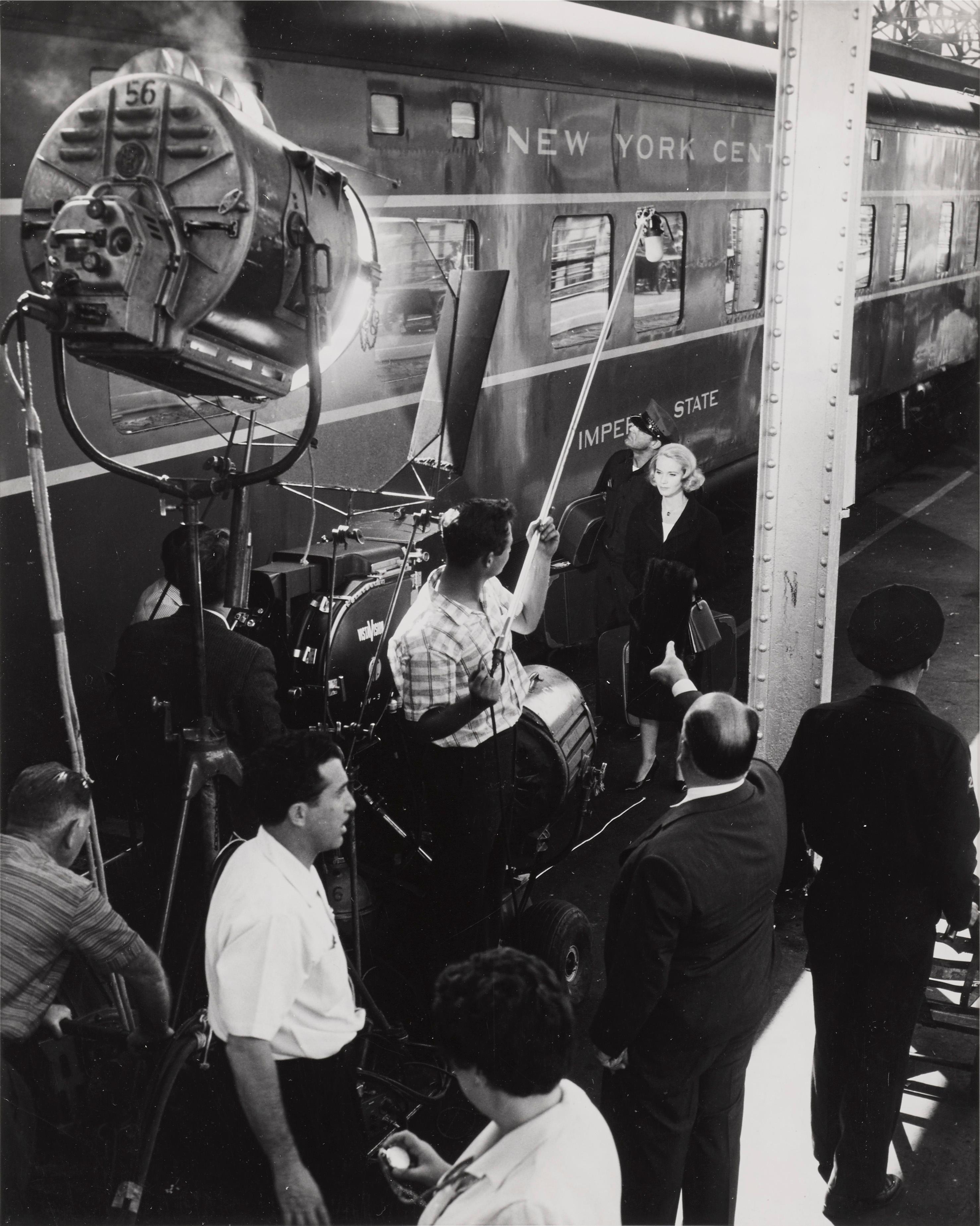 Original double weight candid photographic production still for Alfred Hitchcock's 1959 ThrillerNorth by Northwest.
This film starred Cary Grant, Eva Marie Saint and James Mason. This candid photographic production still shows Alfred Hitchcock