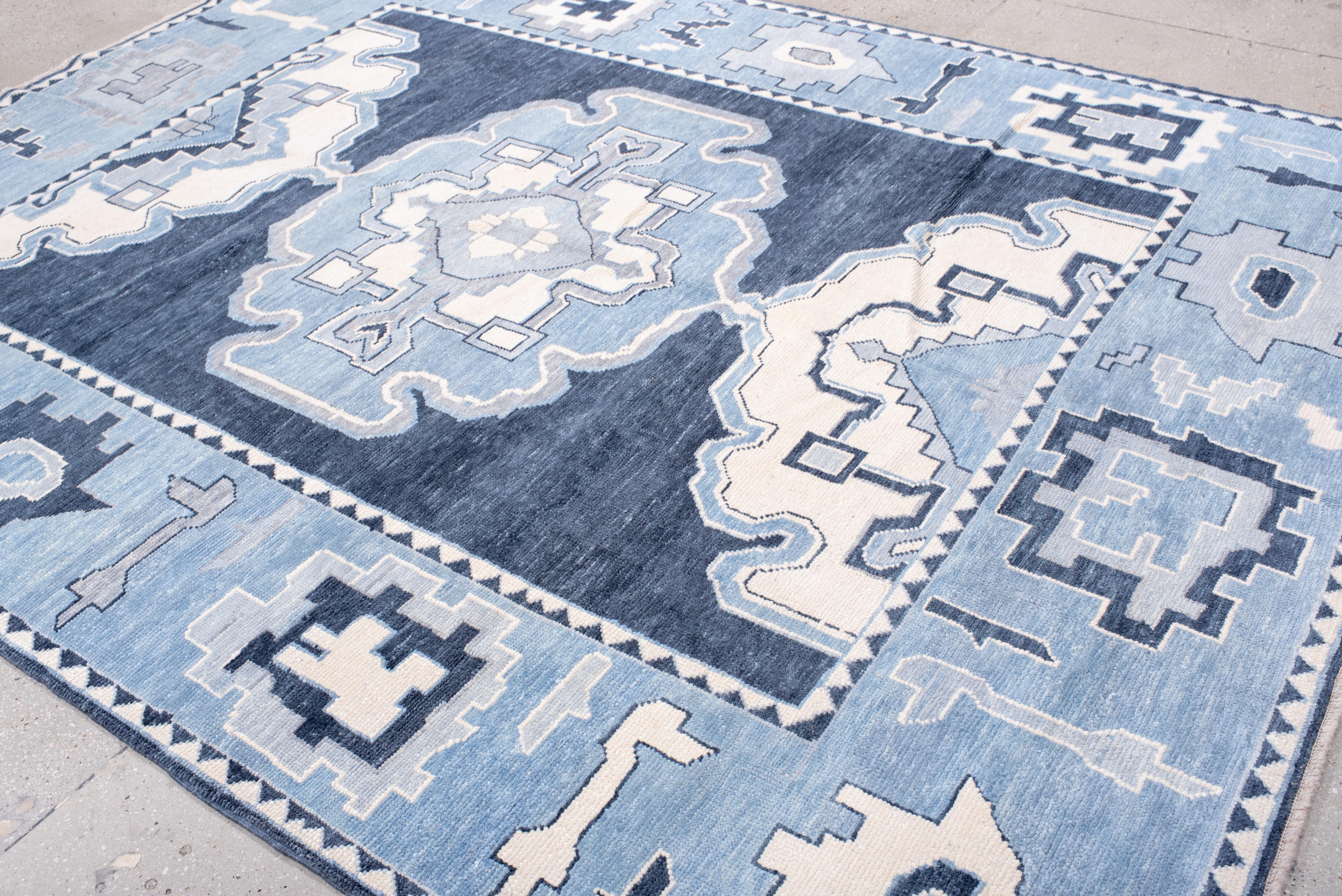 A striking composition of bold geometry and softened symmetry, this Oushak rug bridges heritage and modernity with effortless ease. The oversized central medallion unfolds with architectural precision, while the surrounding motifs maintain a