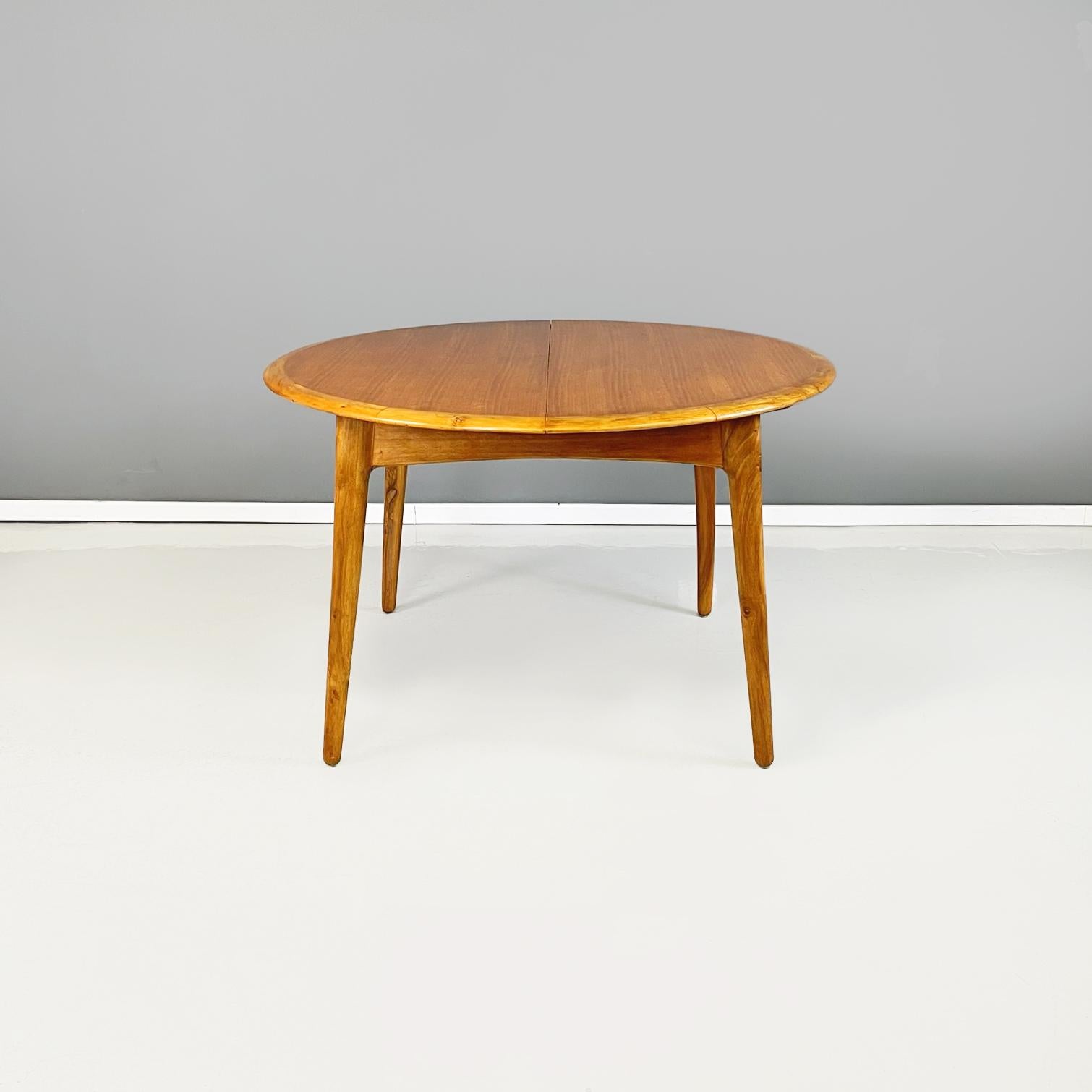 North Europa midcentury Both oval and round Wooden dining table with extensions, 1960s
Solid wood dining table. The table has two extensions in the center, in fact the table top can be both oval and round. Below there are wooden rails that allow