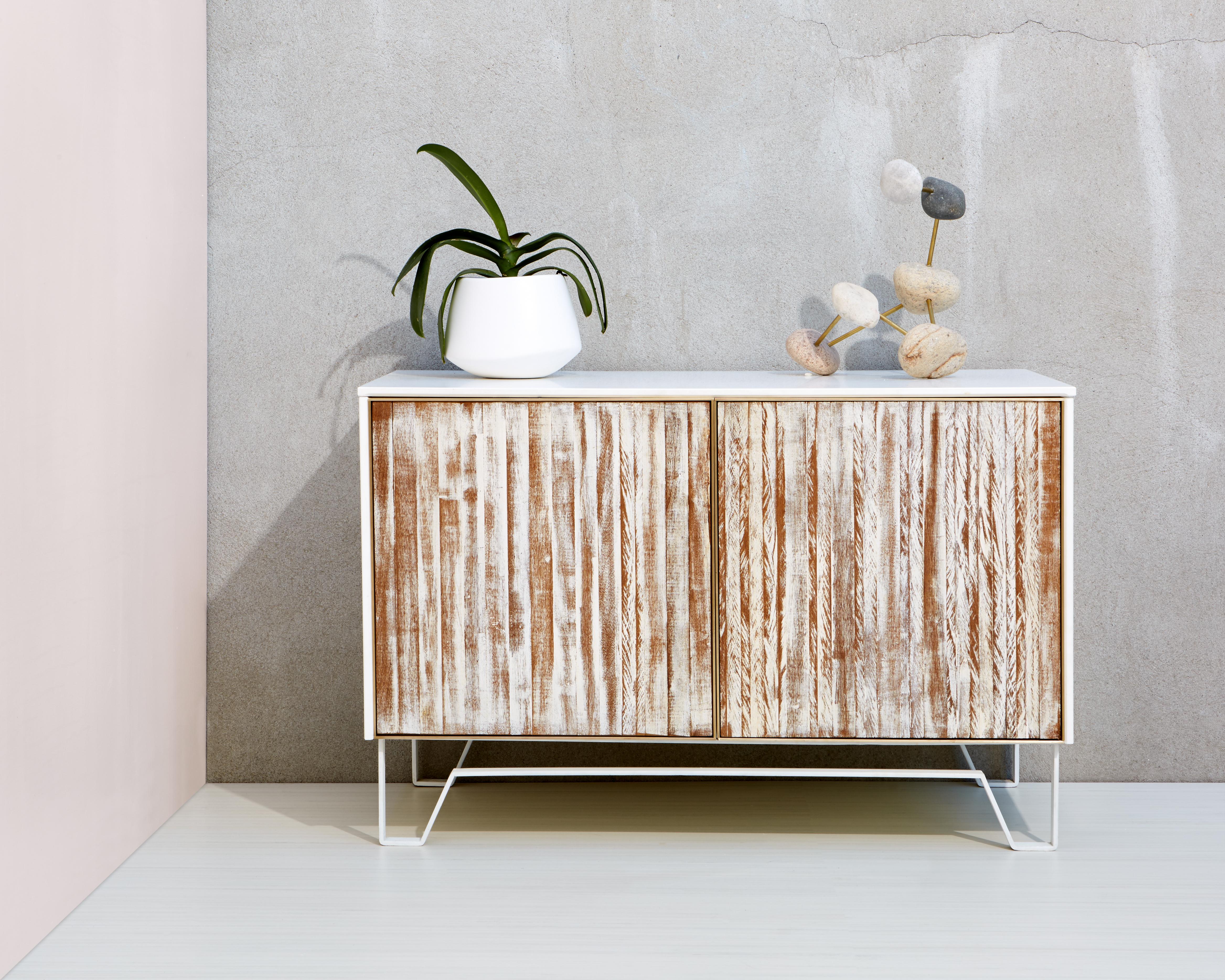 Clean lines of modern materials seamlessly mesh with aged hardwood in this one of a kind furniture piece. Floating effortlessly atop a thin profile of our handcrafted  Loop Legs, the soft matte finish of the exterior panels frames the subtle yet
