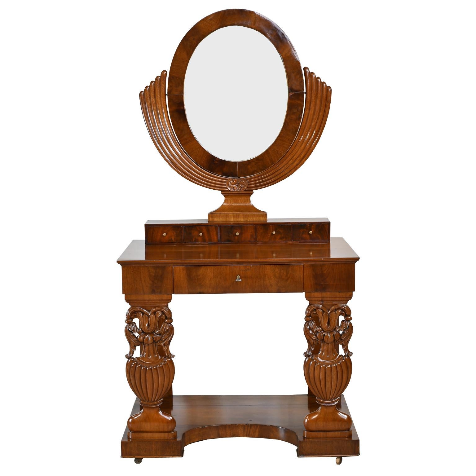 An exquisite early Biedermeier dressing table or console in fine West Indies mahogany, likely from Northern Germany. Features an oval mirror supported on ribbed 