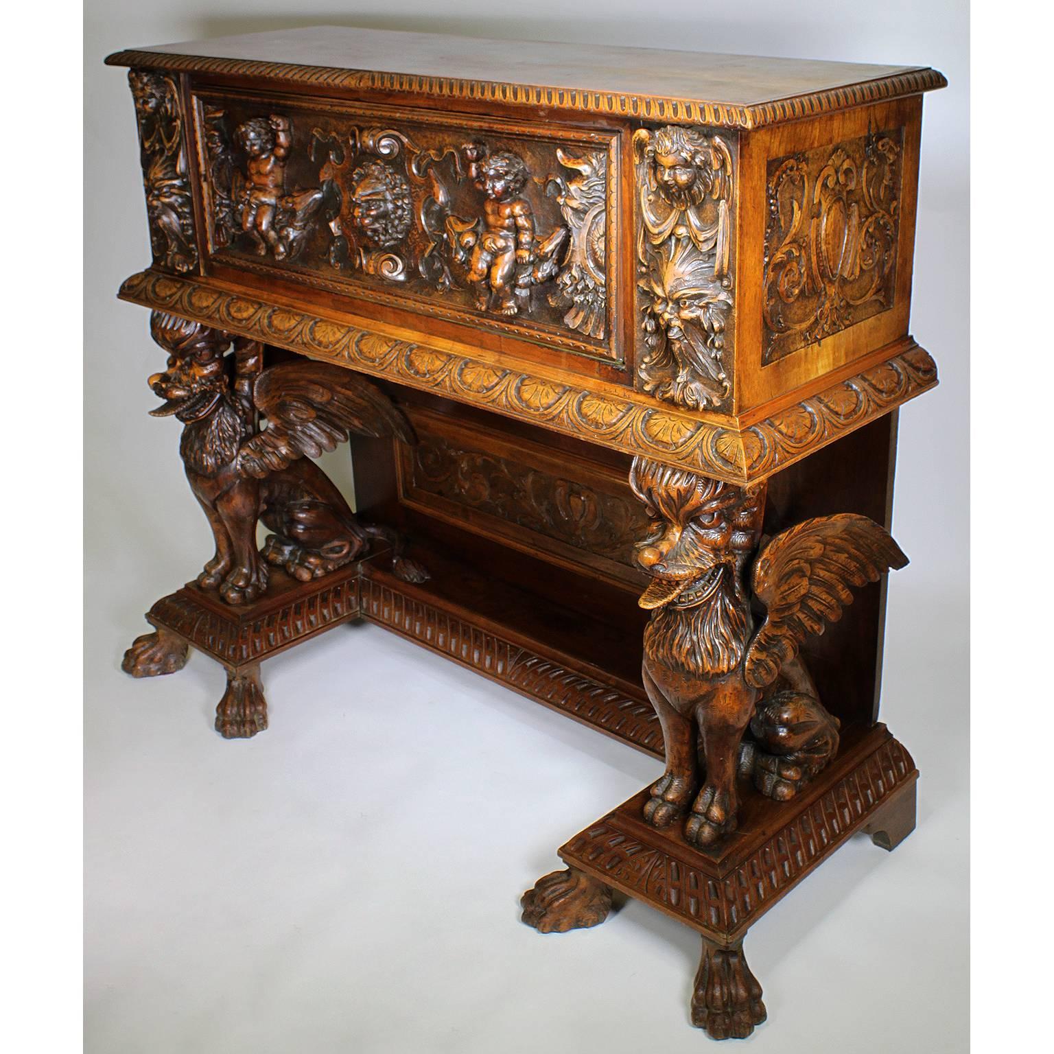 A fine North Italian 19th century Baroque Revival style carved walnut figural cassone drop-front cabinet - Bargueno. The rectangular carved 
