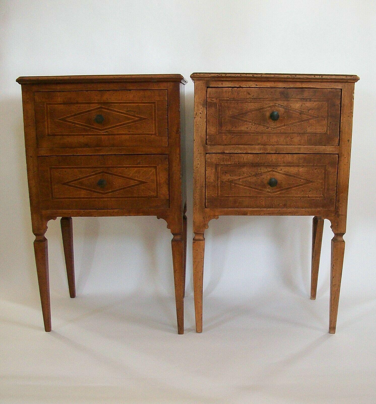 Fine pair of North Italian Neoclassical walnut bedside tables - two drawers to each table - expertly hand crafted - waxed finish - doweled construction (no apparent nails) - featuring diamond inlaid lozenges with rectangular borders in marquetry to