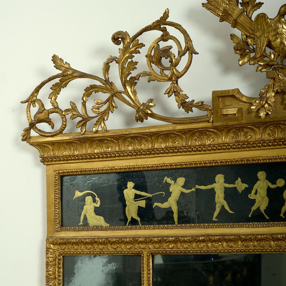 A fine north Italian giltwood and verre eglomisé overmantel mirror, Lombardy, circa 1790.

The cresting with a pair of doves with the attributes of Venus flanked by acanthus scrolls, the verre eglomisé frieze decorated in gilt on a black ground