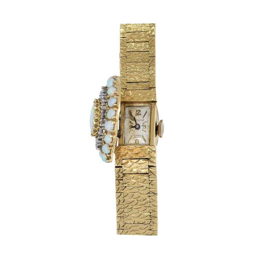 Introducing the North Star 1960's Opal and Diamond Cocktail Watch, a radiant fusion of elegance and sophistication. Crafted with exquisite detail, this captivating timepiece features a luxurious 14kt gold-covered case adorned with opal and diamond