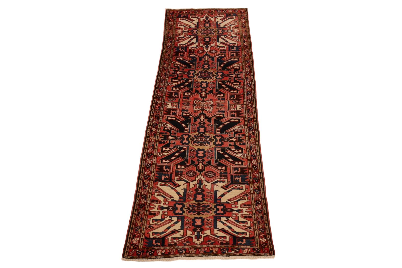 Indulge in the captivating allure of a Northwestern Persian Runner, a rug that effortlessly merges tradition with affordability. With a bold red background, this rug beckons attention and admiration. Its focal point features two grand ivory sun