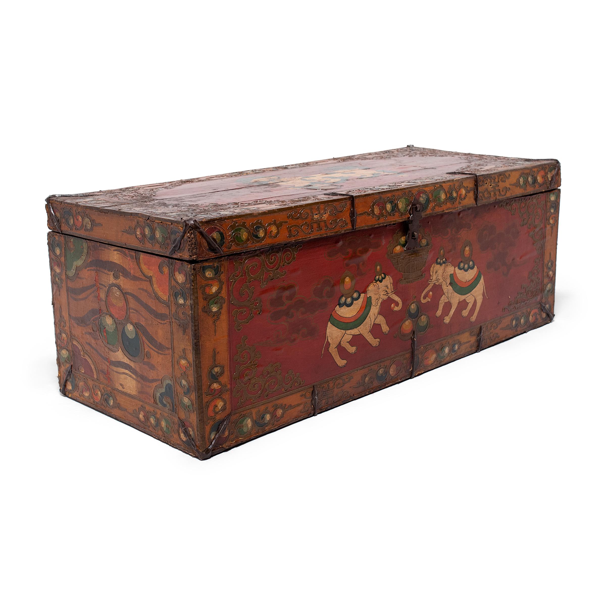This fantastic painted trunk from northern China is lavishly decorated from end to end in the Tibetan style with a rich palette of red, orange, and green. Raised outlines and layers of glossy lacquer lend the chest rich texture and catch the light
