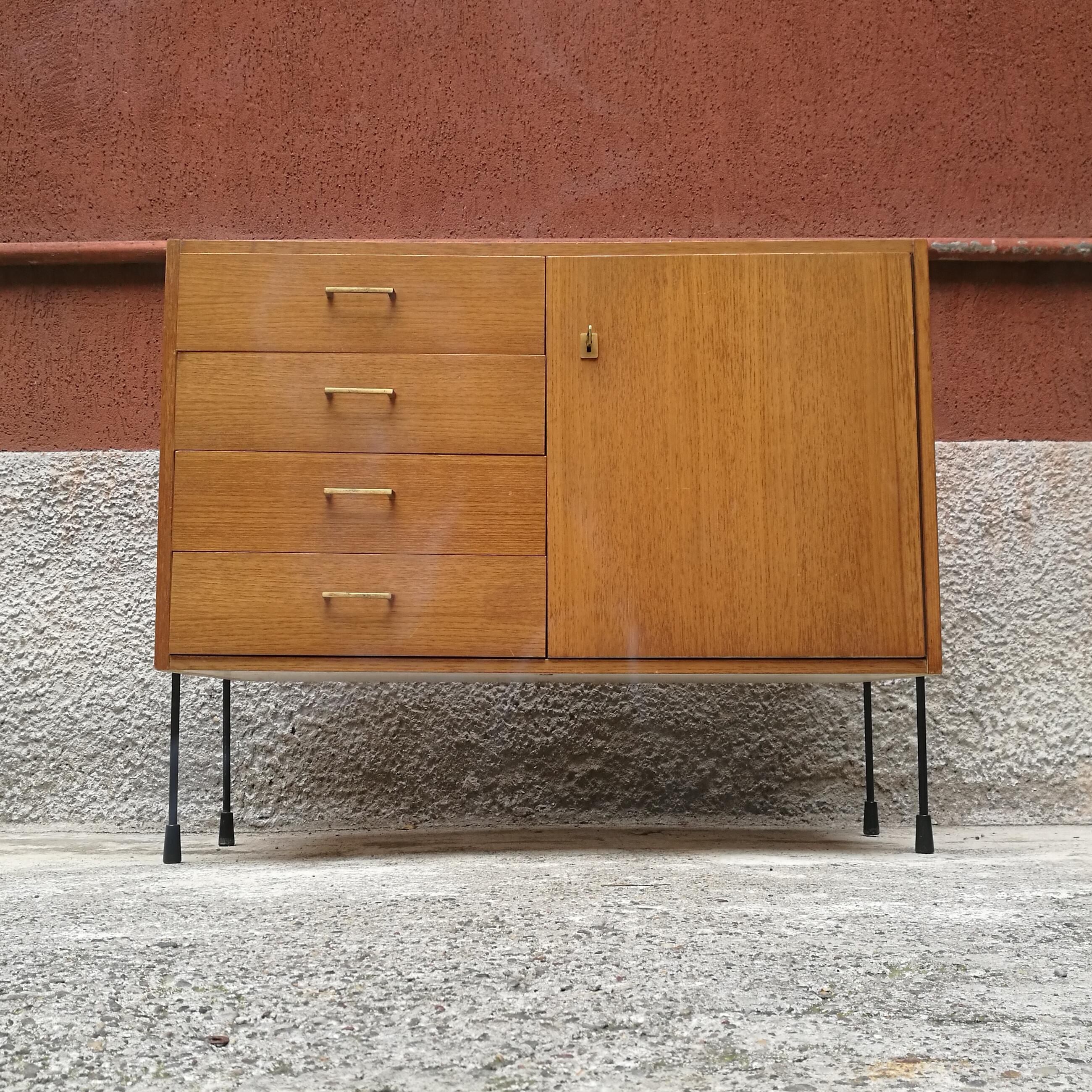 Northern Europe, one-door and drawers, teak, brass and metal sideboard, 1960s
Small light teak sideboard, with drawers and hinged door, brass handles and key and metal rod legs
with the possibility of wall mounting.