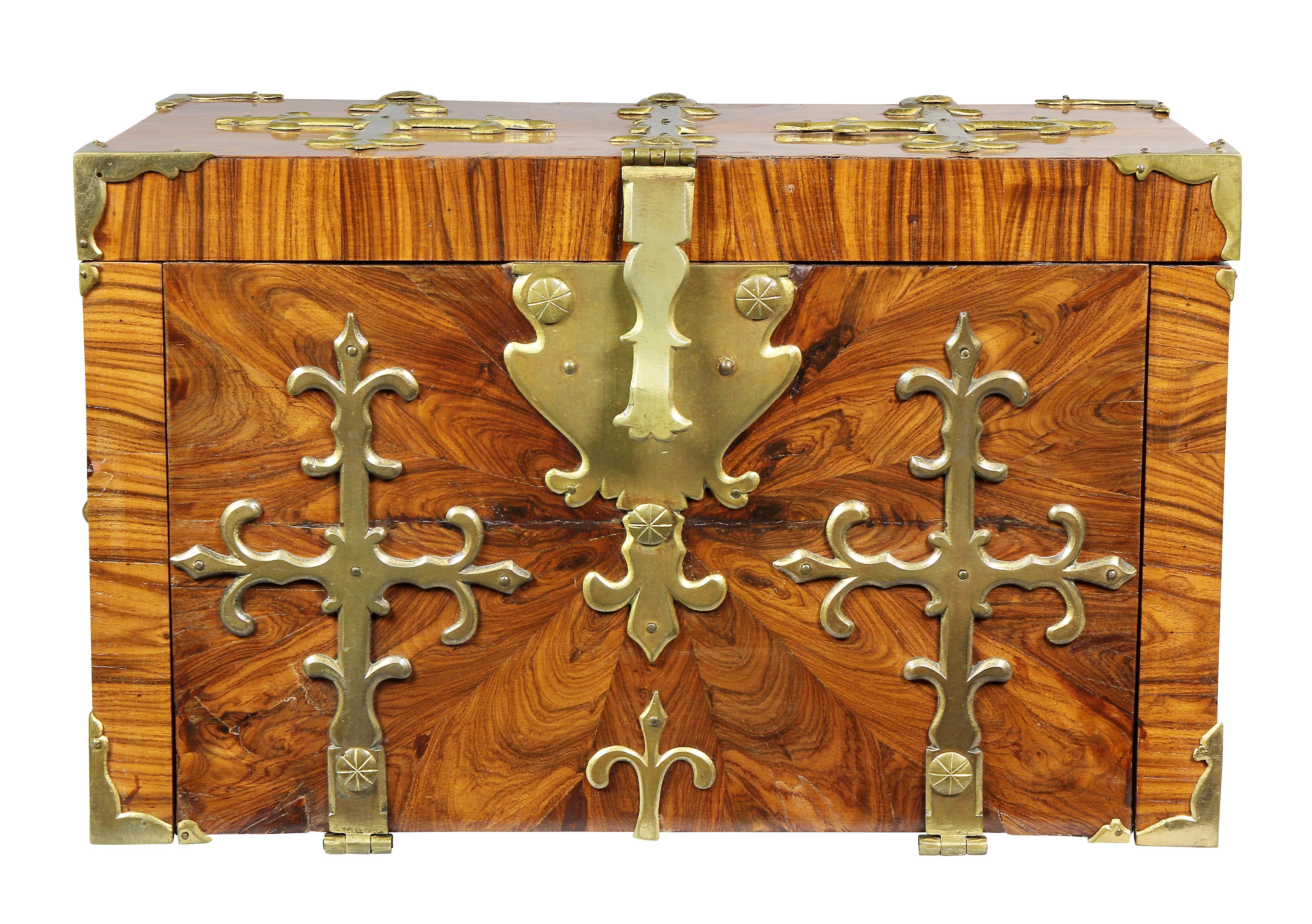 Rectangular hinged lid with overall brass strapping and conforming case with similar brass work, carrying handles, fall front exposing drawers and well.