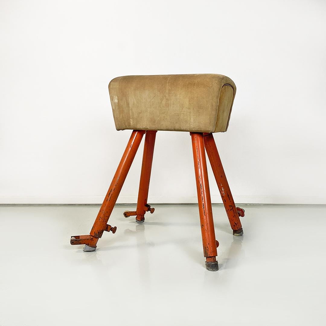Northern European Mid-Century Modern orange metal and brown tan suede gym horse, 1960s.
Gym horse from northern Europe, with four round section orange metal legs, two of which originally provided with wheels for movement, placed on the same short